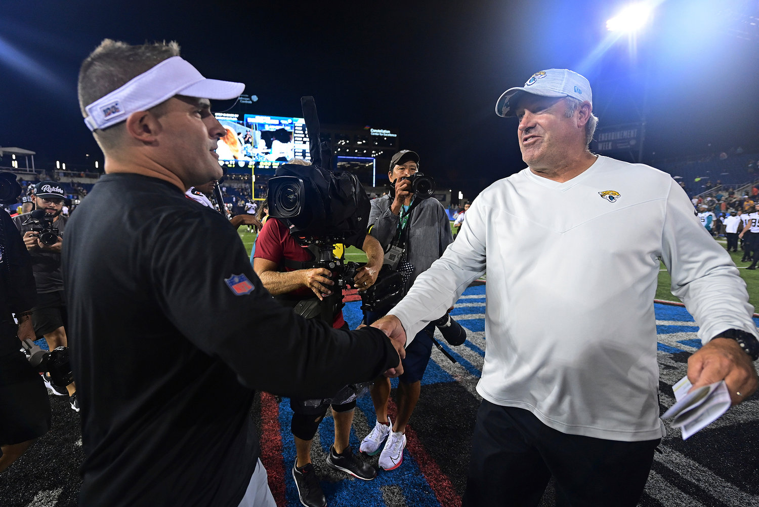 Jacksonville Jaguars coach Doug Pederson, right, shakes hands with Las Vegas Raiders coach Josh McDaniels after the Hall of Fame game on Thursday night in Canton, Ohio. The Raiders won 27-11.