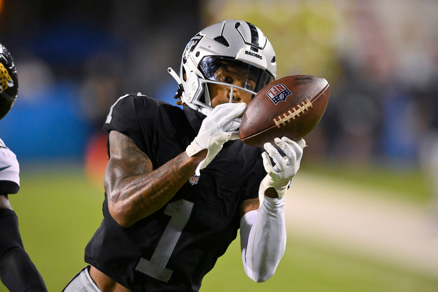 Las Vegas Raiders wide receiver Tyron Johnson (1) can't hang onto a pass during the first half of the team's NFL football exhibition Hall of Fame Game against the Jacksonville Jaguars, Thursday, Aug. 4, 2022, in Canton, Ohio.