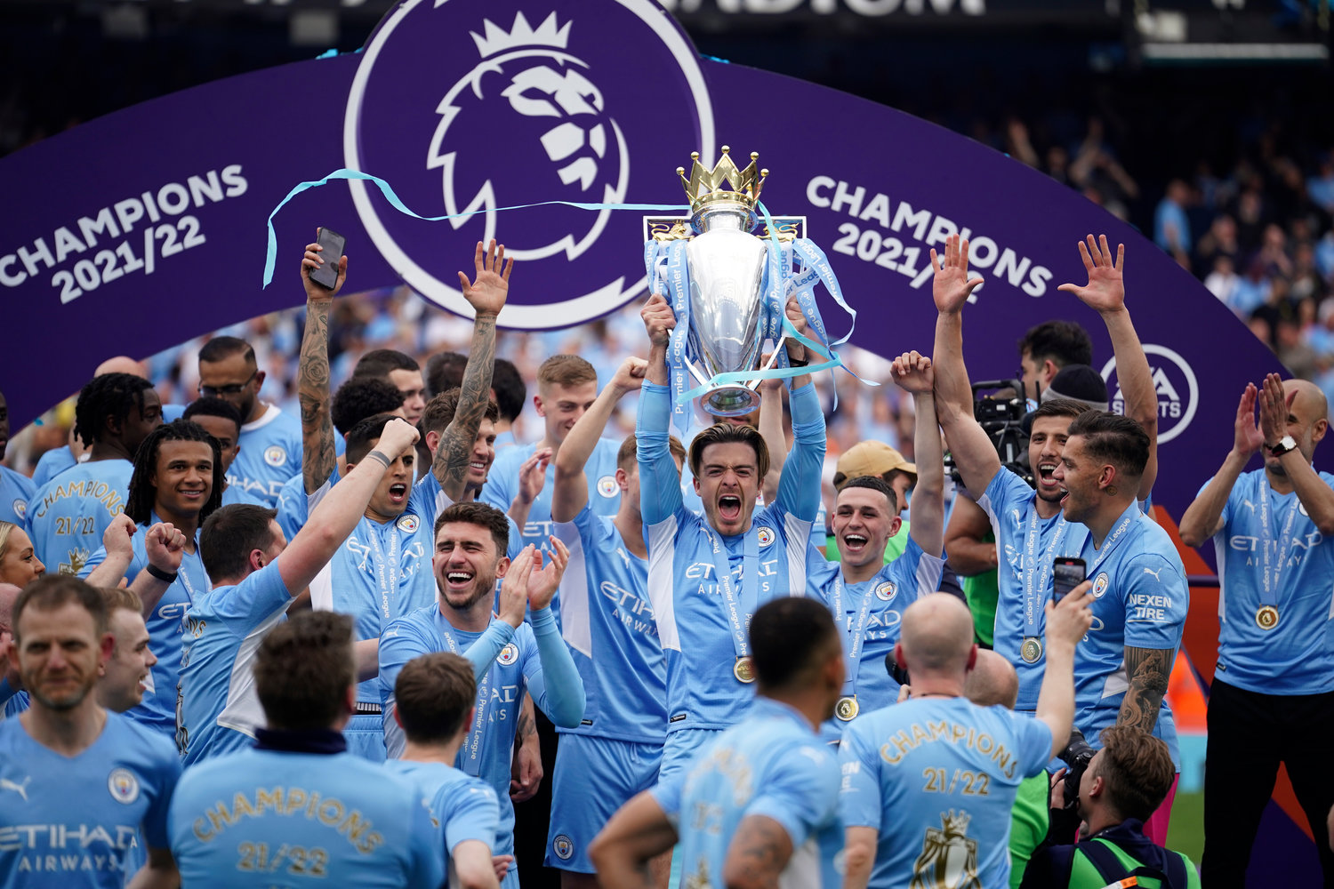 Manchester City players celebrate with trophy after winning the 2022 English Premier League title at the Etihad Stadium in Manchester, England, on May 22. NBC celebrates a milestone this weekend when it begins its 10th season of covering the Premier League.