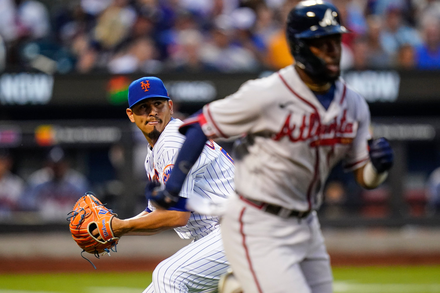 New York Mets starting pitcher Carlos Carrasco throws out Atlanta Braves' Michael Harris II at first base during the third inning of a baseball game, Thursday, Aug. 4, 2022, in New York. (AP Photo/Frank Franklin II)
