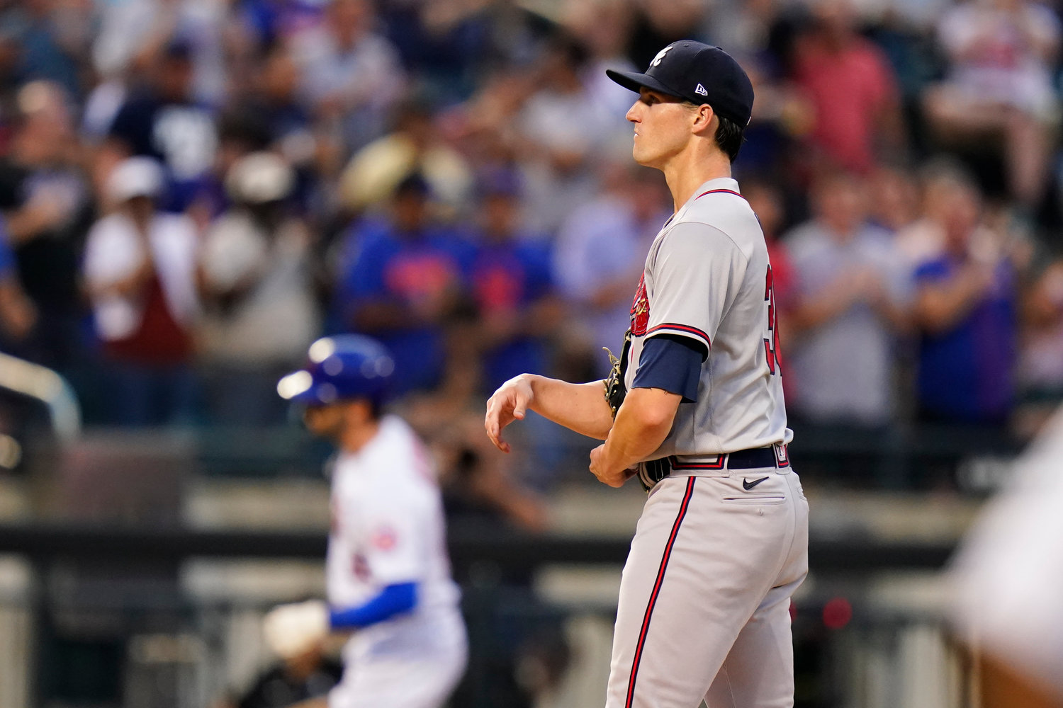 Atlanta Braves starting pitcher Kyle Wright, right, waits as New York Mets' Tyler Naquin runs the bases after hitting a home run during the second inning of a baseball game Thursday, Aug. 4, 2022, in New York. (AP Photo/Frank Franklin II)