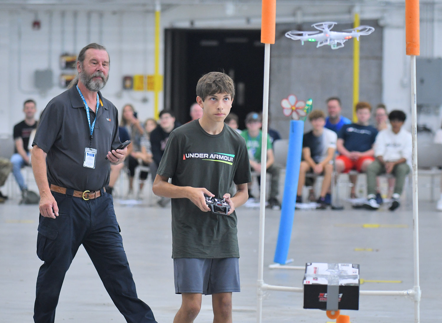 STEELY CONCENTRATION — Oriskany High School student Jack Tagliaferri navigates his drone toward one of the obstacles during the Directorate STEM Outreach Program’s Drone Camp in the hangar at Innovare Advancement Center. Campers competed against each other on the final morning of the camp to see who could navigate the course the quickest and most accurately.