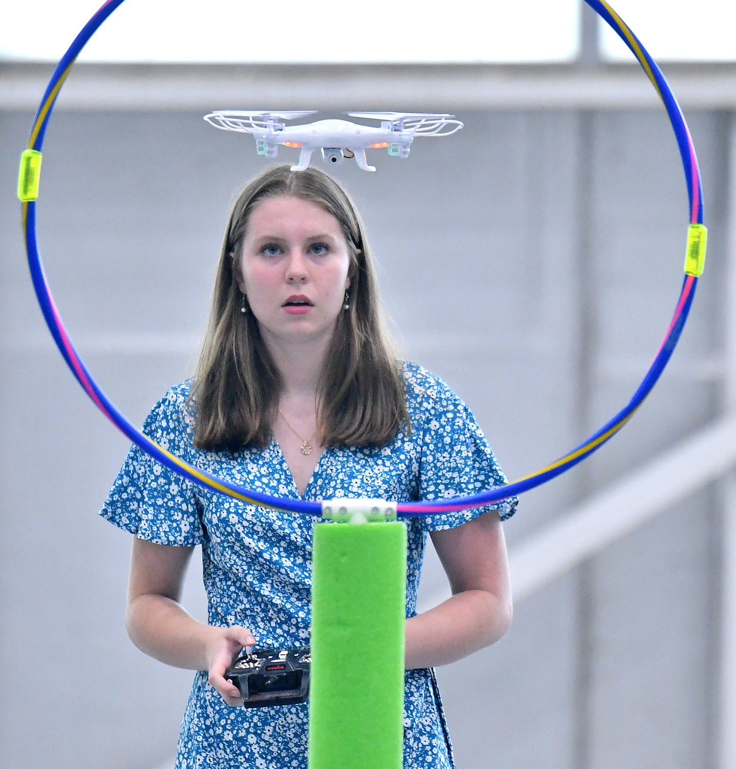 HOVERING — Rome Free Academy junior Teyla McVay pilots her drone into a circular  obstacle during Friday’s Directorate STEM Outreach Program’s Drone Camp challenge at the Innovare Advancement Center.