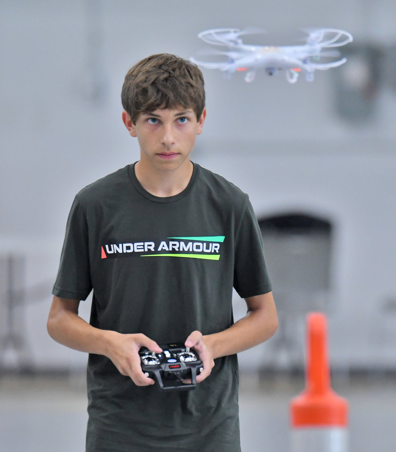 STEELY CONCENTRATION — Oriskany High School student Jack Tagliaferri navigates his drone toward one of the obstacles during the Directorate STEM Outreach Program's Drone Camp in the hangar at Innovare Advancement Center. Campers competed against each other on the final morning of the camp to see who could navigate the course the quickest and most accurately.
