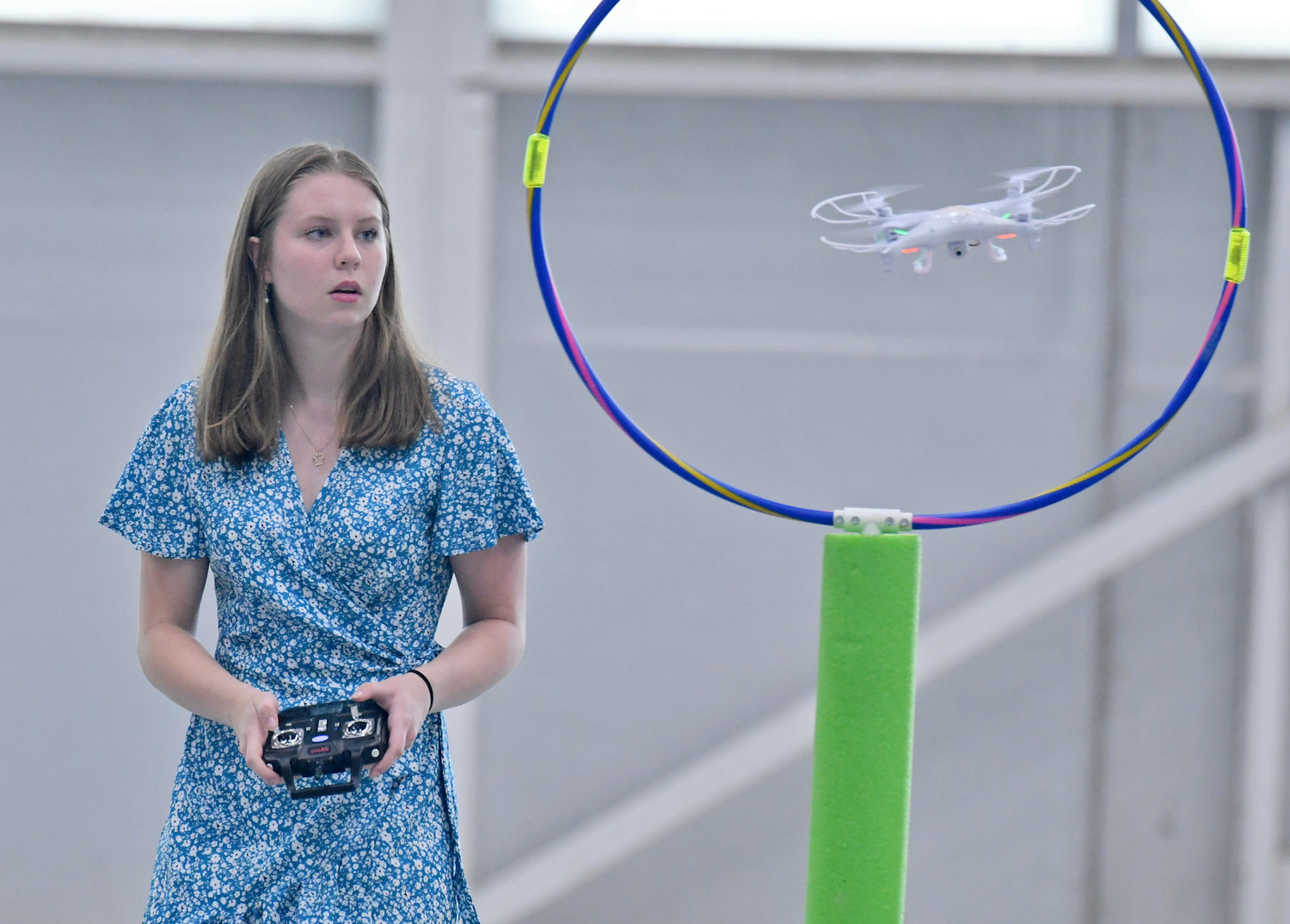 RFA junior Teyla McVay navigates her drone through one of the obstacles during the Directorate STEM Outreach Program's Drone Camp in the hangar at Innovare Advancement Center. Campers competed against each other on the final morning of the camp to see who could navigate the course the quickest and most accurately.