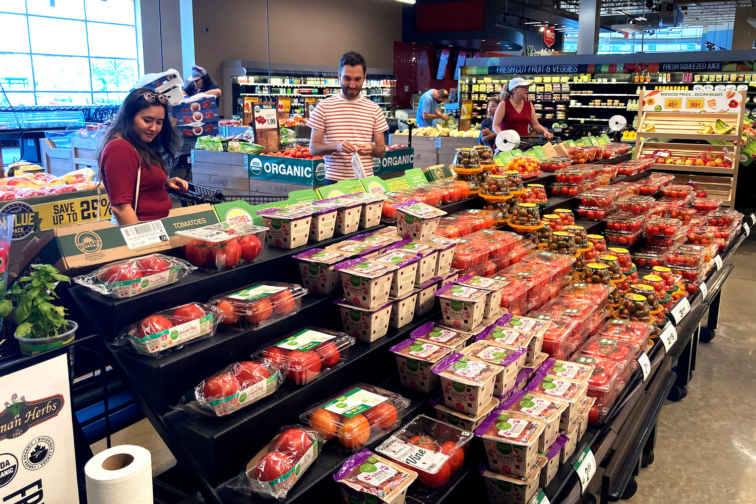 Shoppers shop at a grocery store in Glenview, Ill., Monday, July 4, 2022.  U.S. demand for grocery delivery is cooling as food prices rise. Some shoppers are shifting to less expensive grocery pickup, while others are returning to the store.