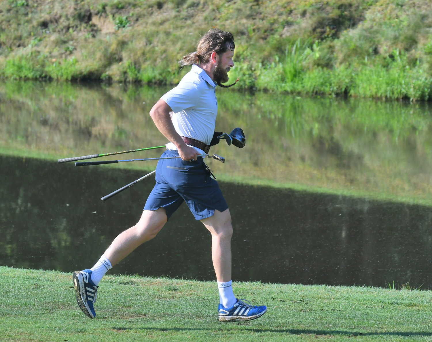 Speedgolfer Rob Hogan from Ireland runs by the seventh hole Monday morning during the New York Speedgolf Open at Rome Country Club. Hogan finished second in the tournament.