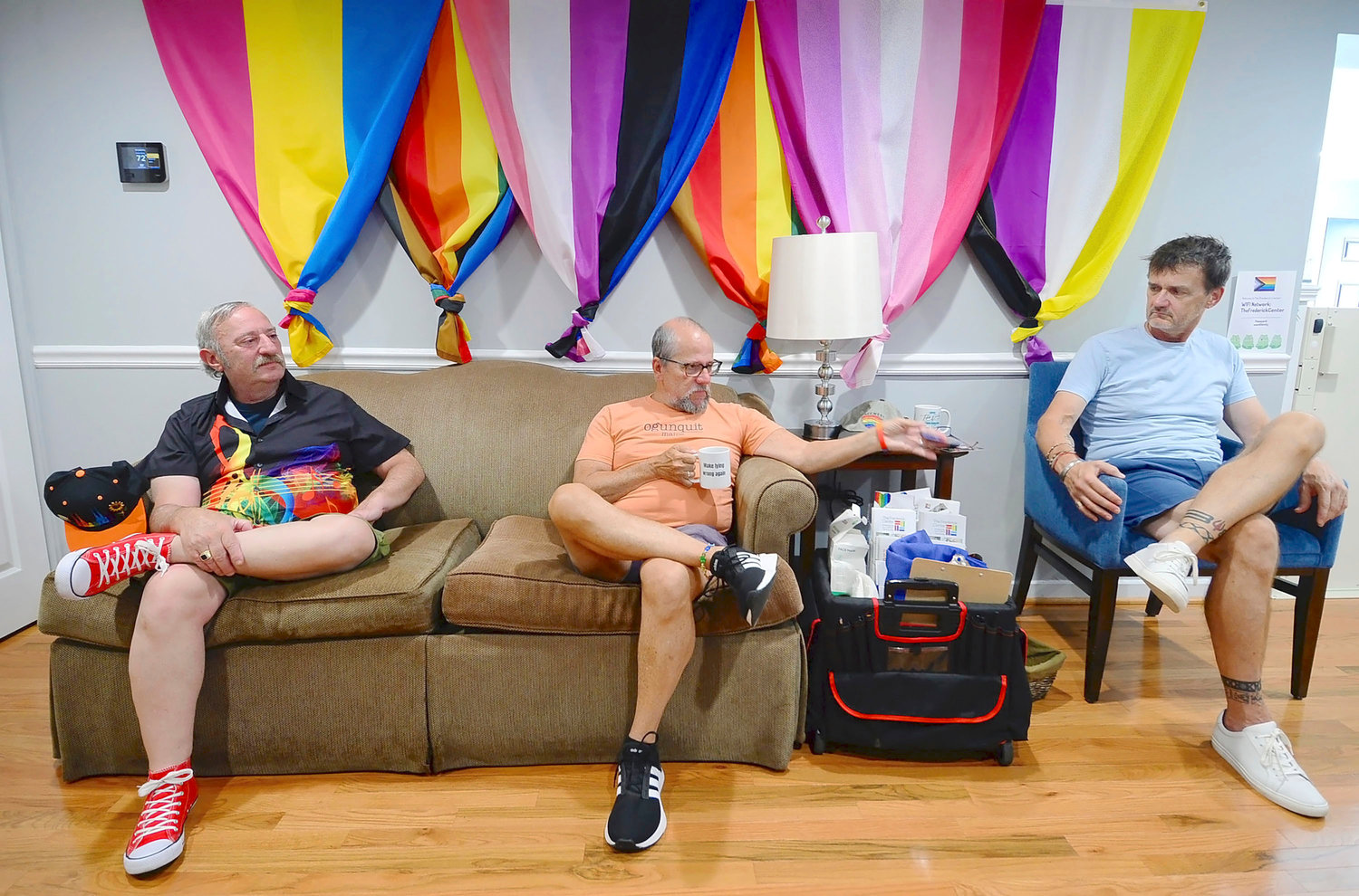 Stuart Harvey, middle, leads a support group meeting for the over 65 years and older LGBTQ community at the Frederick Center on July 13 in Frederick, Md. Listening in is Stephen Parnes, left, and Steven Gibson, right.