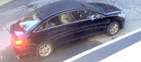 This is the black or dark-colored sedan that the suspects rode in when they fled the scene.