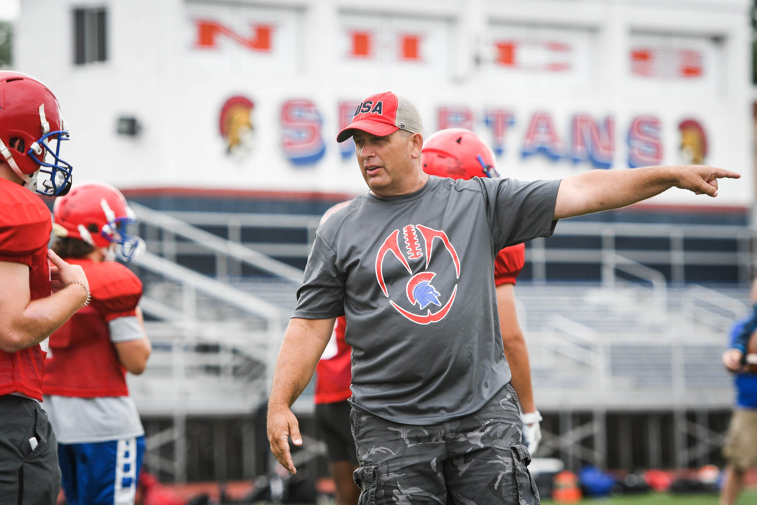 MAKING A POINT — New Hartford assistant coach Keith Kempney instructs players during a seven-on-seven football camp on Tuesday at Don Edick Field in New Hartford. The Spartans open the 2022 season on the road against Rome Free Academy at 6:30 p.m. on Friday, Sept. 2, at RFA Stadium.