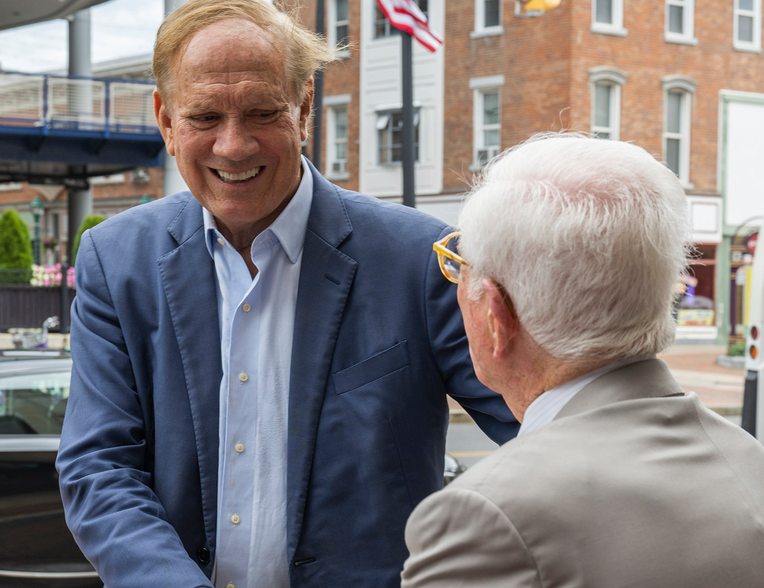 Former Governor George Pataki, left, shakes hands with Neal Golub after speaking in front of Proctors Theatre on State Street in Schenectady Tuesday, Aug. 9.