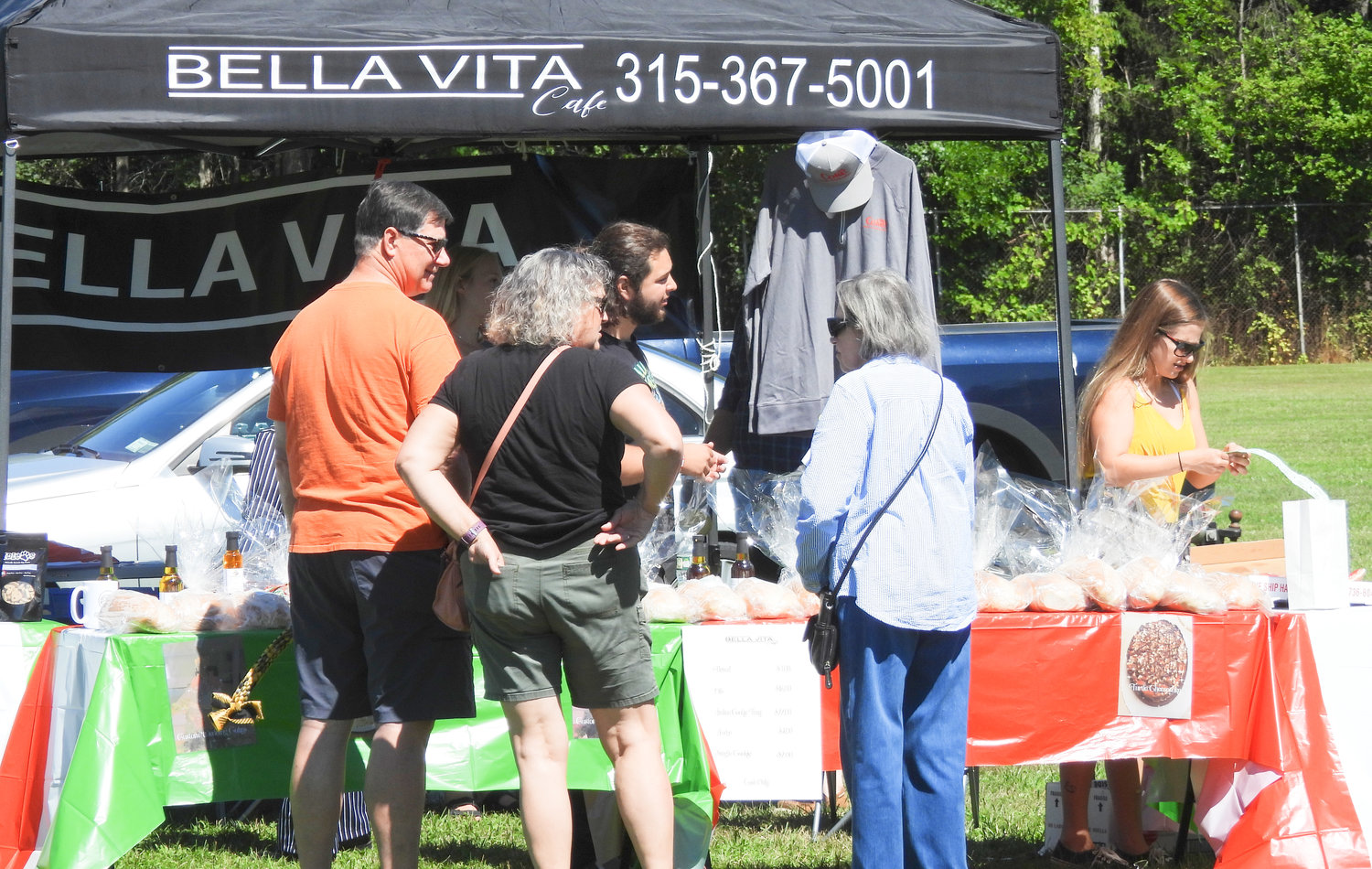 People sample and buy goods from Bella Vita at Wanderers' Rest's 2022 Woofstock fundraiser in Oneida on Saturday, Aug. 13.