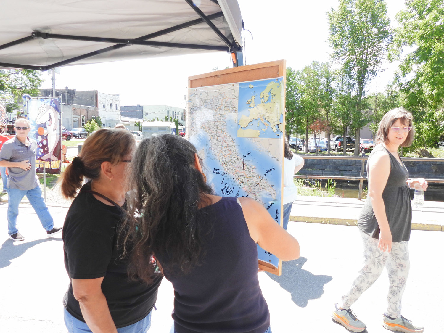 Residents came out for a day of fun and a taste of Italy at the Canastota Italian Heritage Festival on Saturday, Aug. 13. In this photo, local residents mark down on a display, what part of Italy their family came from.