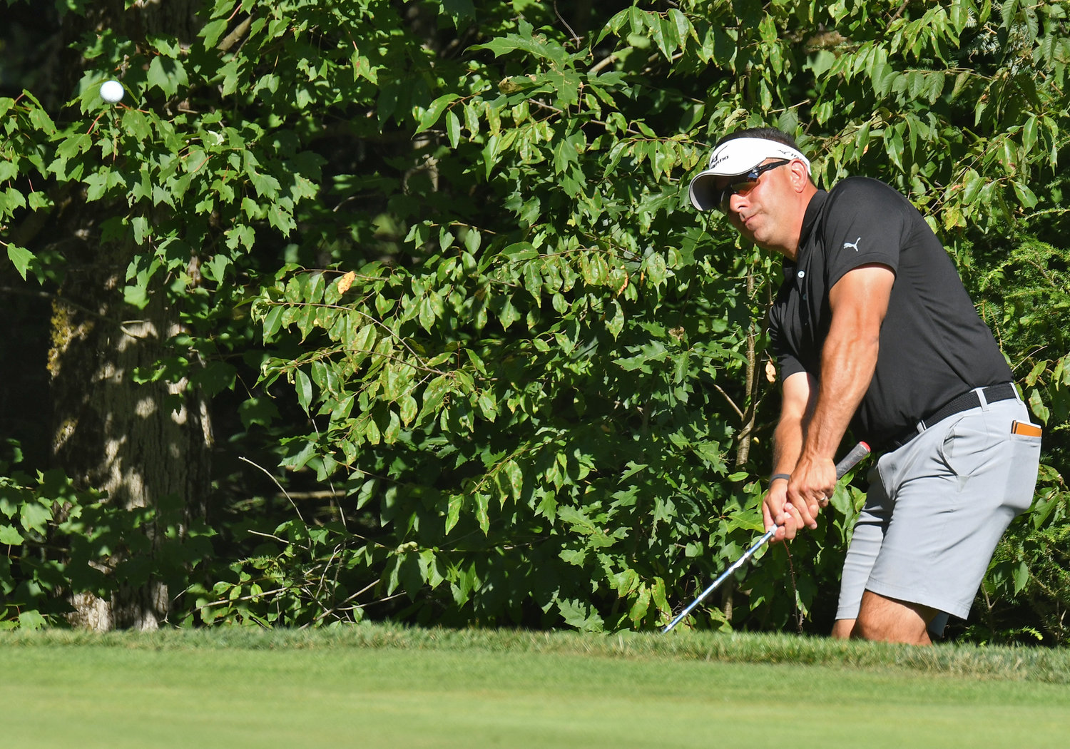Aaron Fiorini chips to the par 3 17th hole on Sunday afternoon at McConnellsville Country Club during the second round of the Rome City Men's Amateur Golf Championship.