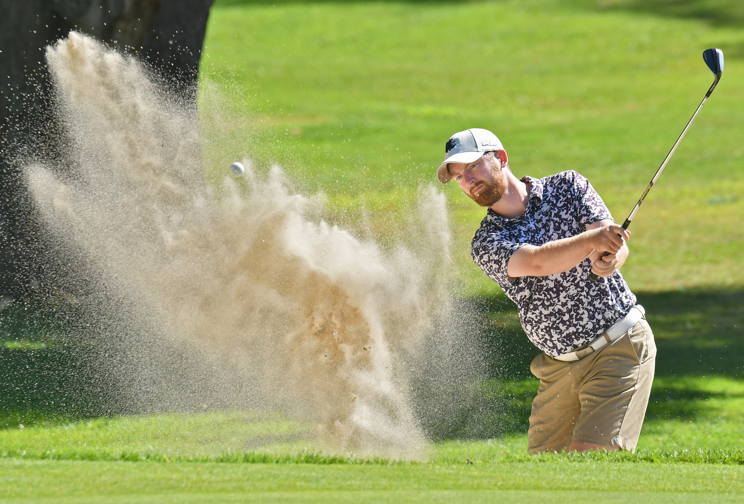 Dan O'Connor blasts out of the 15th greenside sand trap on Sunday afternoon at McConnellsville Country Club during the final round of the Rome City Men's Amateur Golf Championship. O'Connor finished sixth with a two-day score of 161.