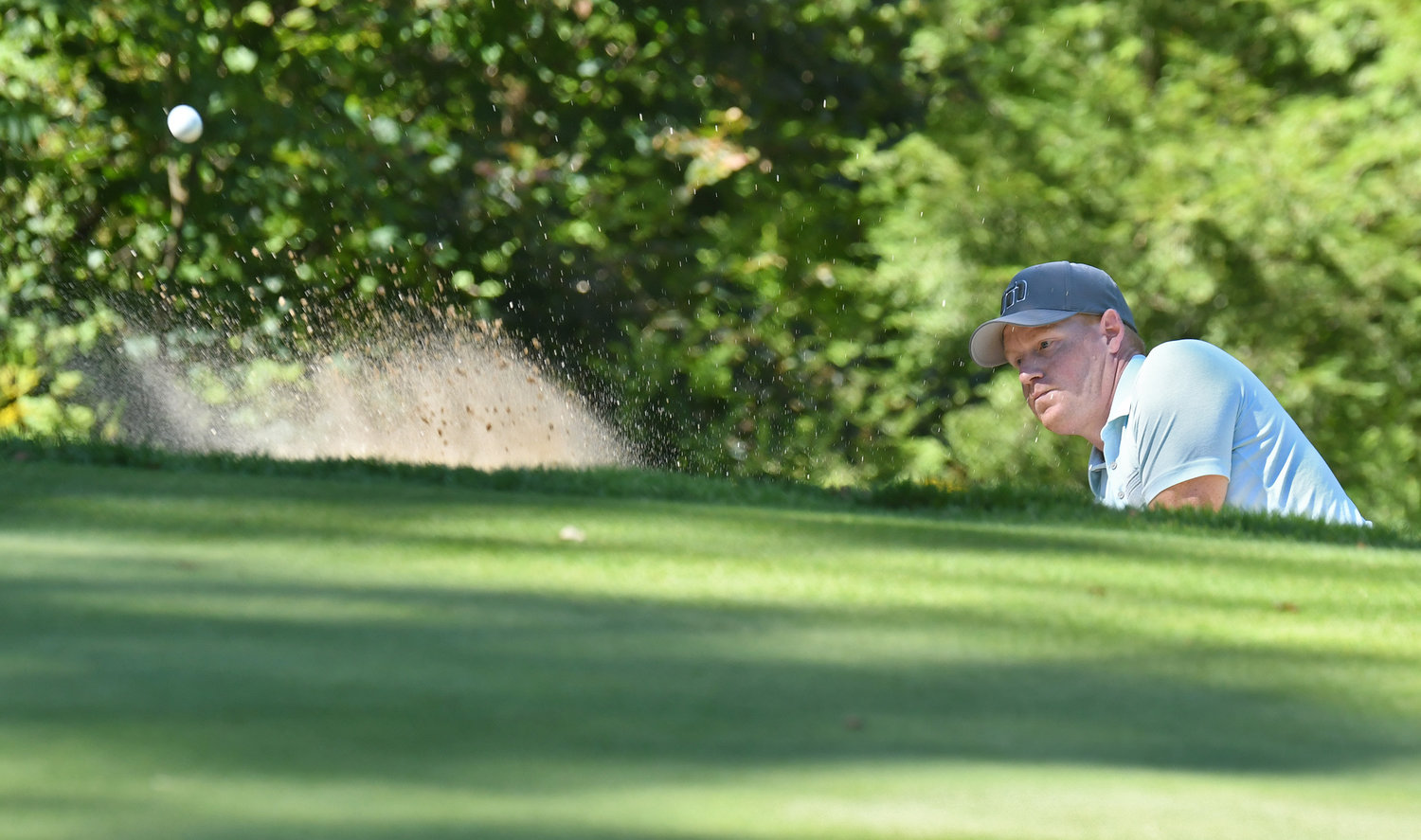 Brad Waters blasts out of the greenside sand trap on the 14th hole on Sunday afternoon at McConnellsville Country Club during the final round of the Rome City Men's Amateur Golf Championship. Waters finished 15th with a two-day score of 166.