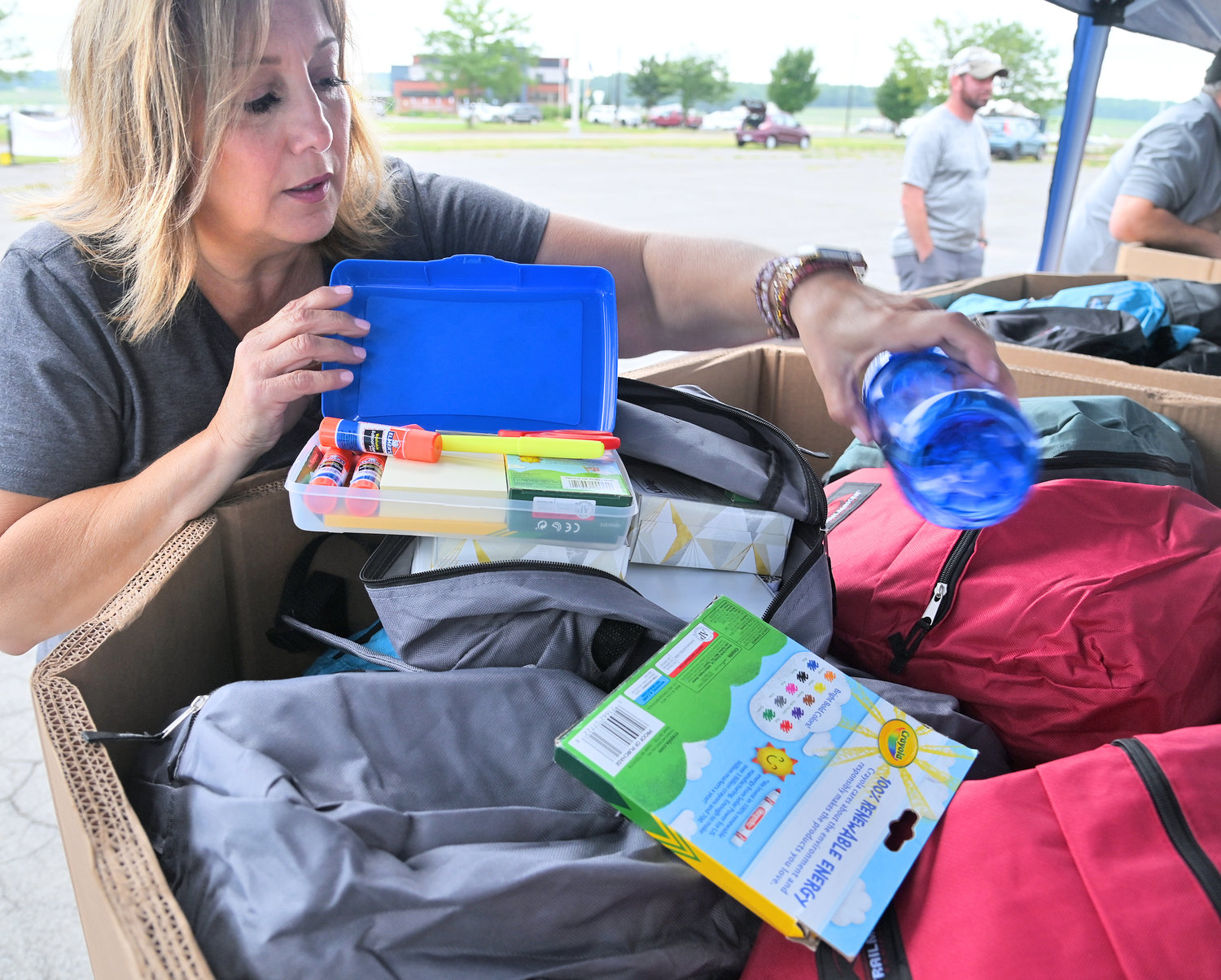 BOOK BAG GIVEAWAY – Wendy Calabrese, director of employee engagement at Kris-Tech and a Kris-Tech Care Team member, shows the contents of one of the 500 book bags that will be given away during Kris-Tech’s Hungry for Education book bag giveaway.