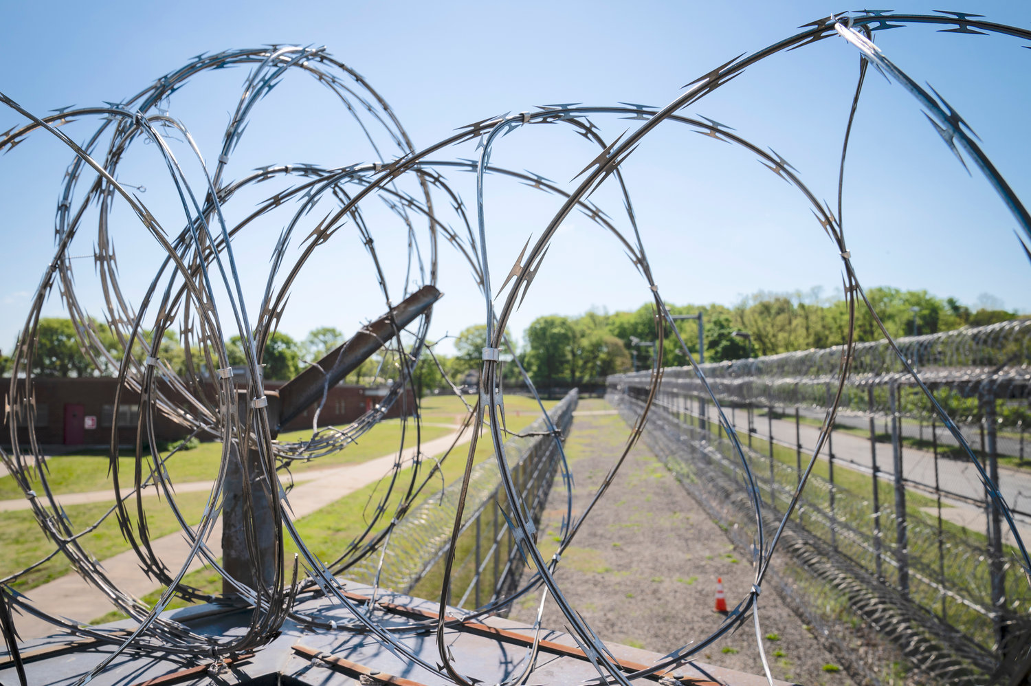 Razor wire surrounds the perimeter fencing at the former Arthur Kill Correctional Facility, Tuesday, May 11, 2021, in the Staten Island borough of New York. The facility was purchased by Broadway Stages in 2017 and has been transformed into a film and television studio. Much of the prison was preserved as a set, lending authenticity to scenes in productions.