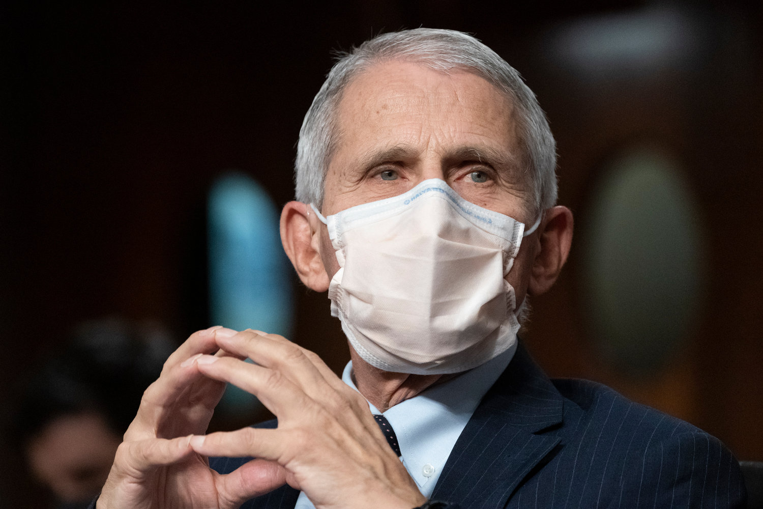 FILE - Dr. Anthony Fauci, director of the National Institute of Allergy and Infectious Diseases, listens during opening statements during a Senate Health, Education, Labor, and Pensions Committee hearing on Capitol Hill, Nov. 4, 2021, in Washington. Fauci, the nation's top infectious disease expert who became a household name, and the subject of partisan attacks, during the COVID-19 pandemic, announced Monday he will depart the federal government in December after more than 5 decades of service.  (AP Photo/Alex Brandon, File)