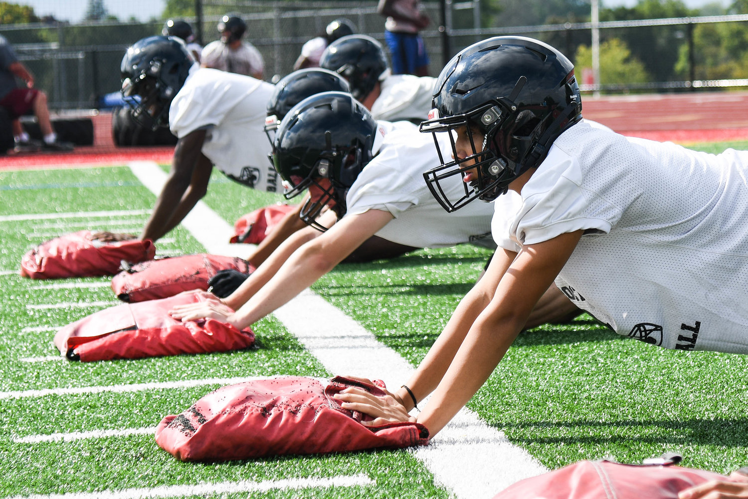 Thomas R. Proctor football players prepare to push sandbags across the turf during conditioning drills at practice on Monday at D'Alessandro Stadium in Utica. The team is coming off a 4-4 season last fall after not participating during the altered spring 2021 season due to COVID-19-related considerations.