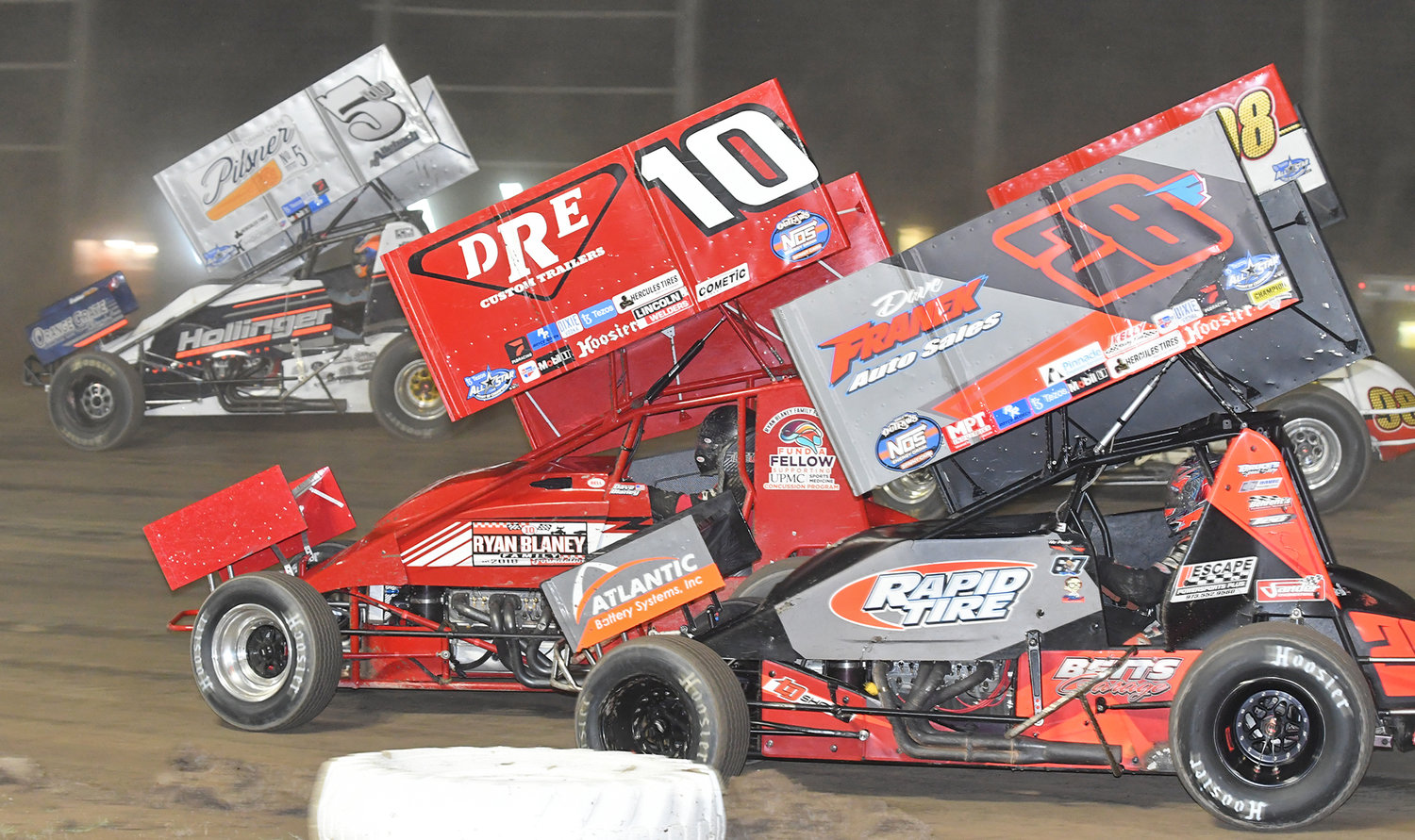 TIGHT RACING — Lucas Wolfe in the No. 5W, Dave Blaney in the No. 10, Davie Franek in the No. 28F and Joe Trenca in the No. 98 on the outside battle it out in the first lap of the 410 Tezo All-Star Sprint Car Series race on Saturday night at Utica-Rome Speedway.