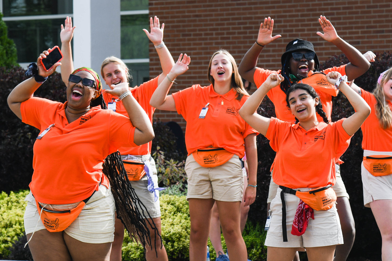 New student orientation members cheer while helping Utica University’s Class of 2026 move in on Tuesday.