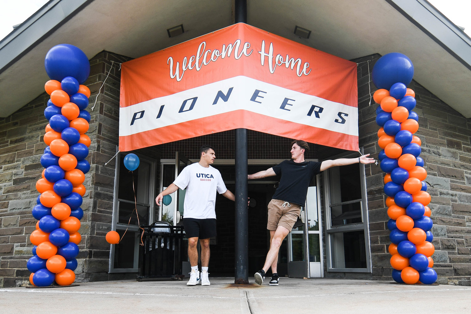 Sean Weaver and Brady Maloney strike a pose while helping Utica University’s Class of 2026 move into their dorms on Tuesday.