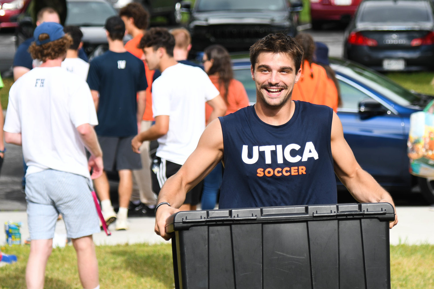 Nico Leonard and other members of the Utica University soccer team help freshman move into their dorms on Tuesday.