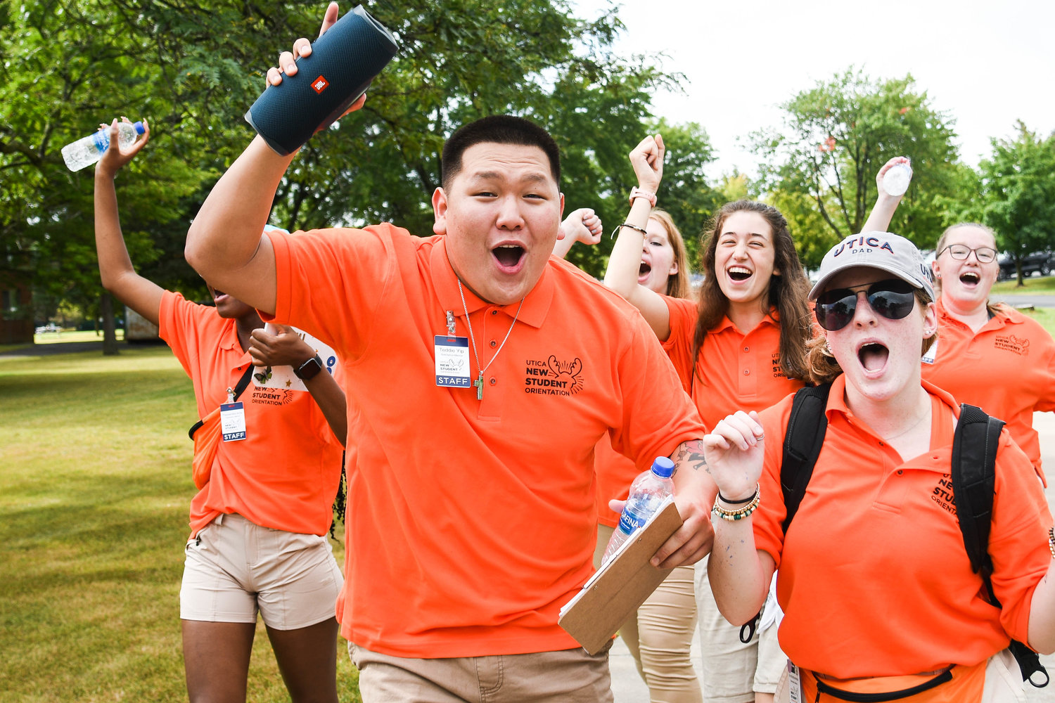 Teddie Yip and other student orientation members cheer and dance while helping Utica University’s Class of 2026 move in on Tuesday.