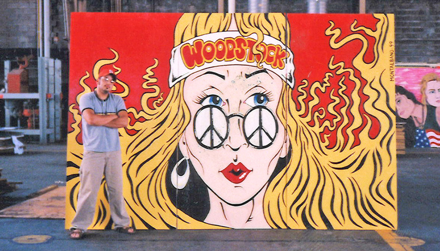 Artist Mark Montalbano with the Woodstock Girl panel he was asked to recreate after the festival because the original piece was destroyed.