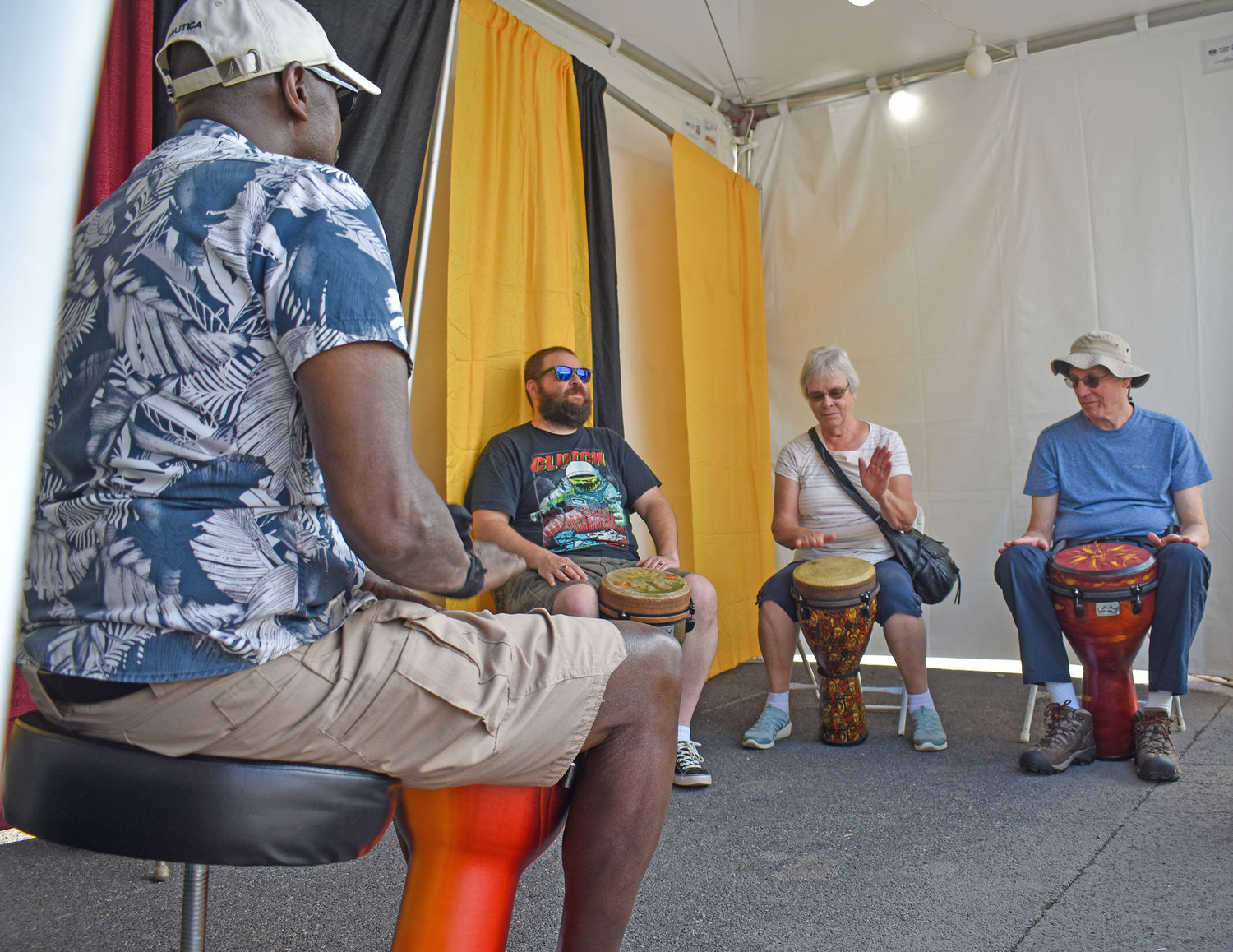 Local musician John Heard guides a hand drum workshop at the New York State Fair’s Pan-African Village.