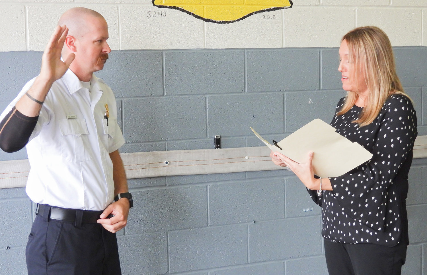 Scott Burbidge is sworn in as deputy chief at the Oneida Fire Department at a ceremony on Friday, Aug. 26.