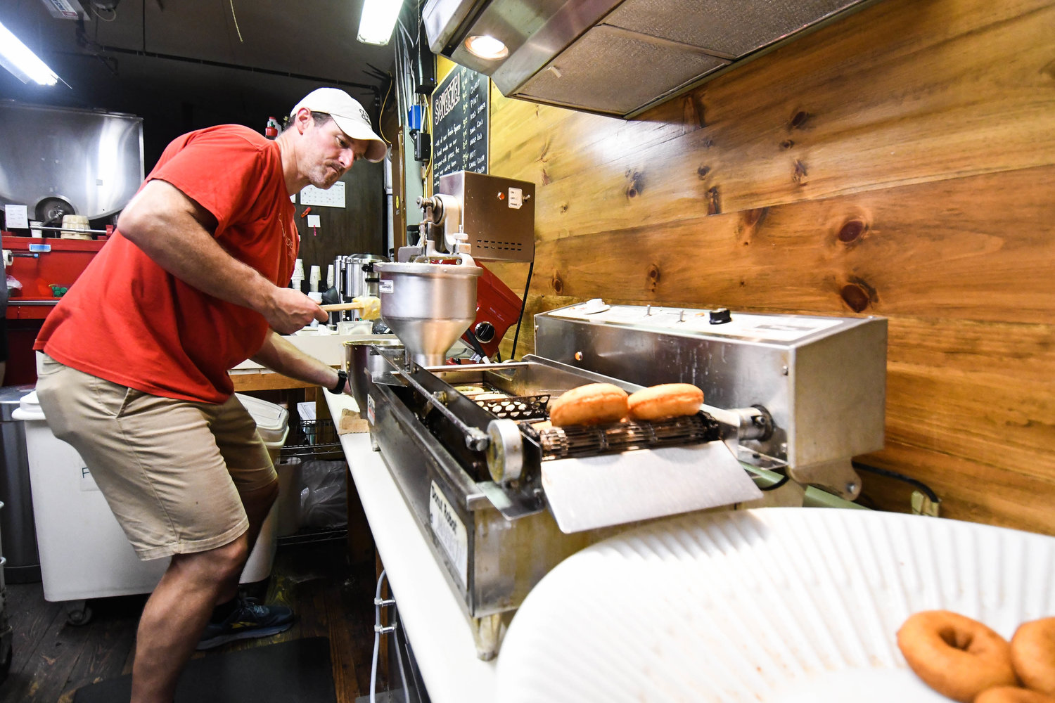 Kevin Ziesenitz makes cider donuts in the kitchen at Clinton Cider Mill on Friday. The popular local attraction opened it's doors for the first time this season on Friday.