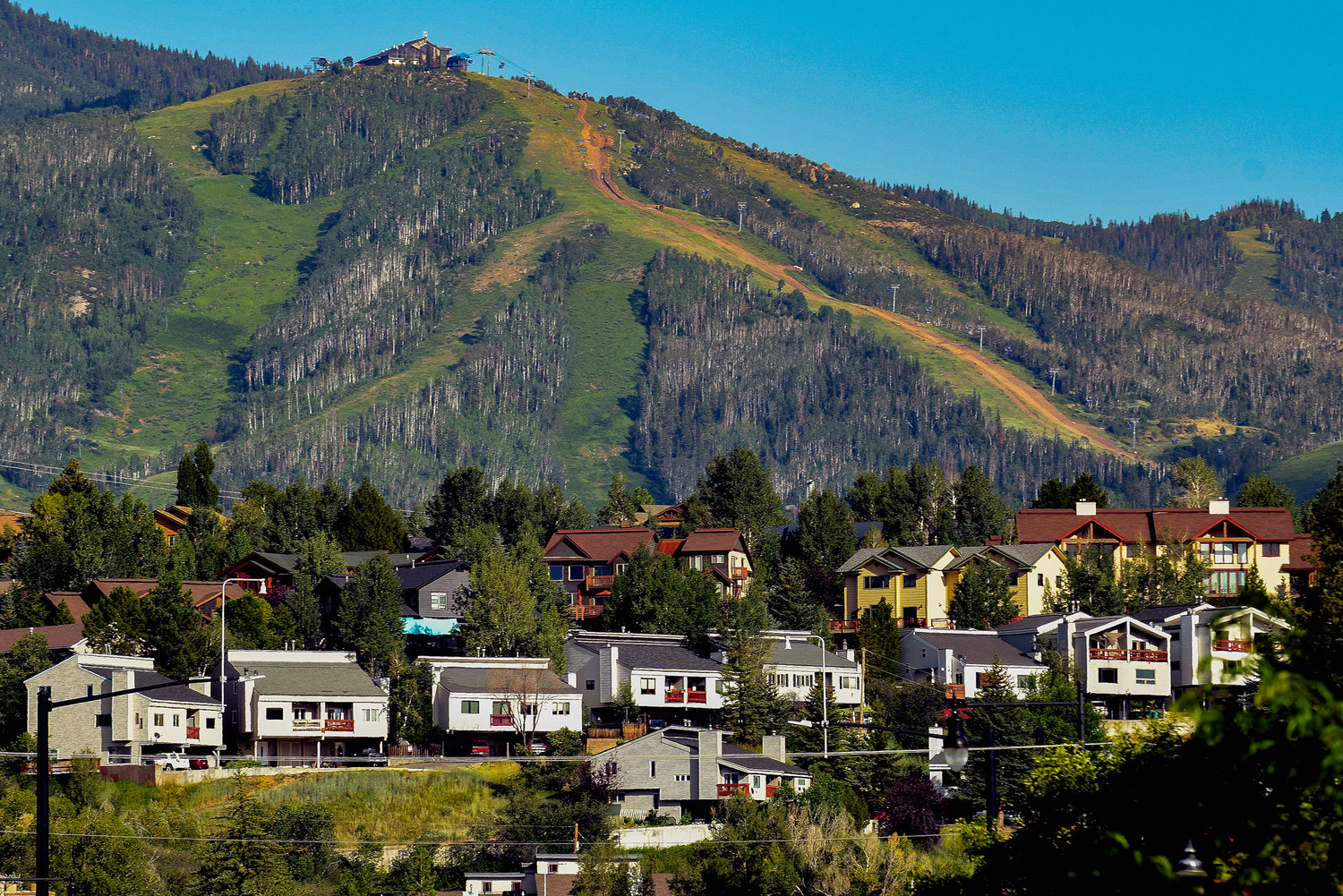 Houses dot the landscape at Colorado's Steamboat Ski Resort, Wednesday, Aug. 3, 2022, in Steamboat Springs, Colo. The city council passed a rule in June that could prove to be a model for other vacation towns: A ban on new short-term rentals in most of the city and a ballot measure to tax bookings at 9% to fund affordable housing.