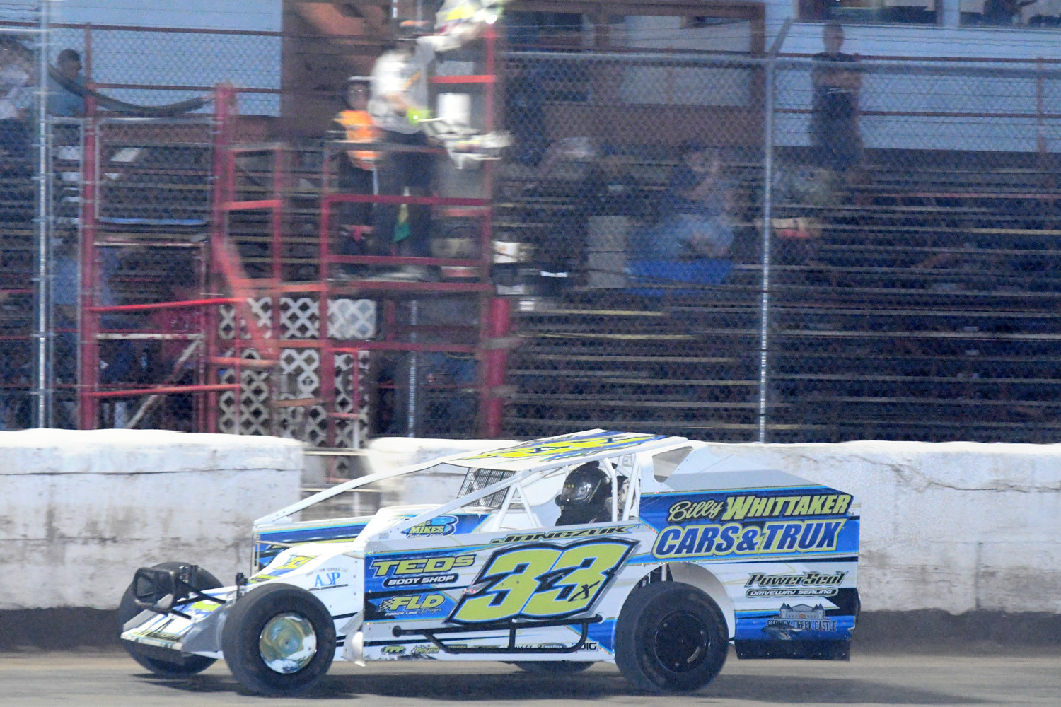 Durhamville’s Matt Janczuk races under the dual checkered flags of Utica-Rome Speedway flag man Joe Kriss to win his 10th straight sportsman feature race last Friday night and 11th feature of 2022.