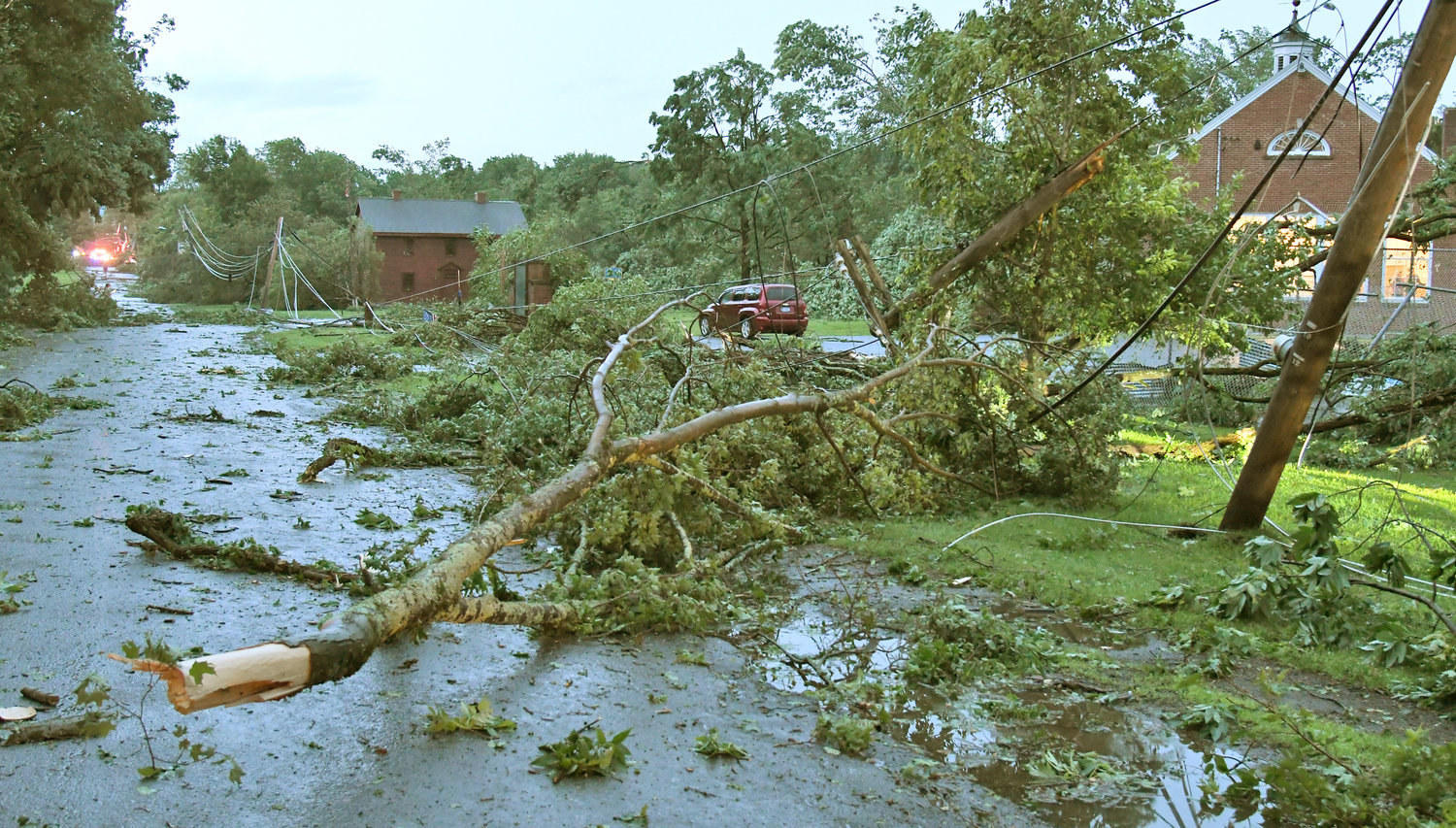 Trees and power lines are scattered across streets, lawns and homes on Main Street in Westernville in this file photo of damage from a tornado that hit the town of Western on July 8, 2021.