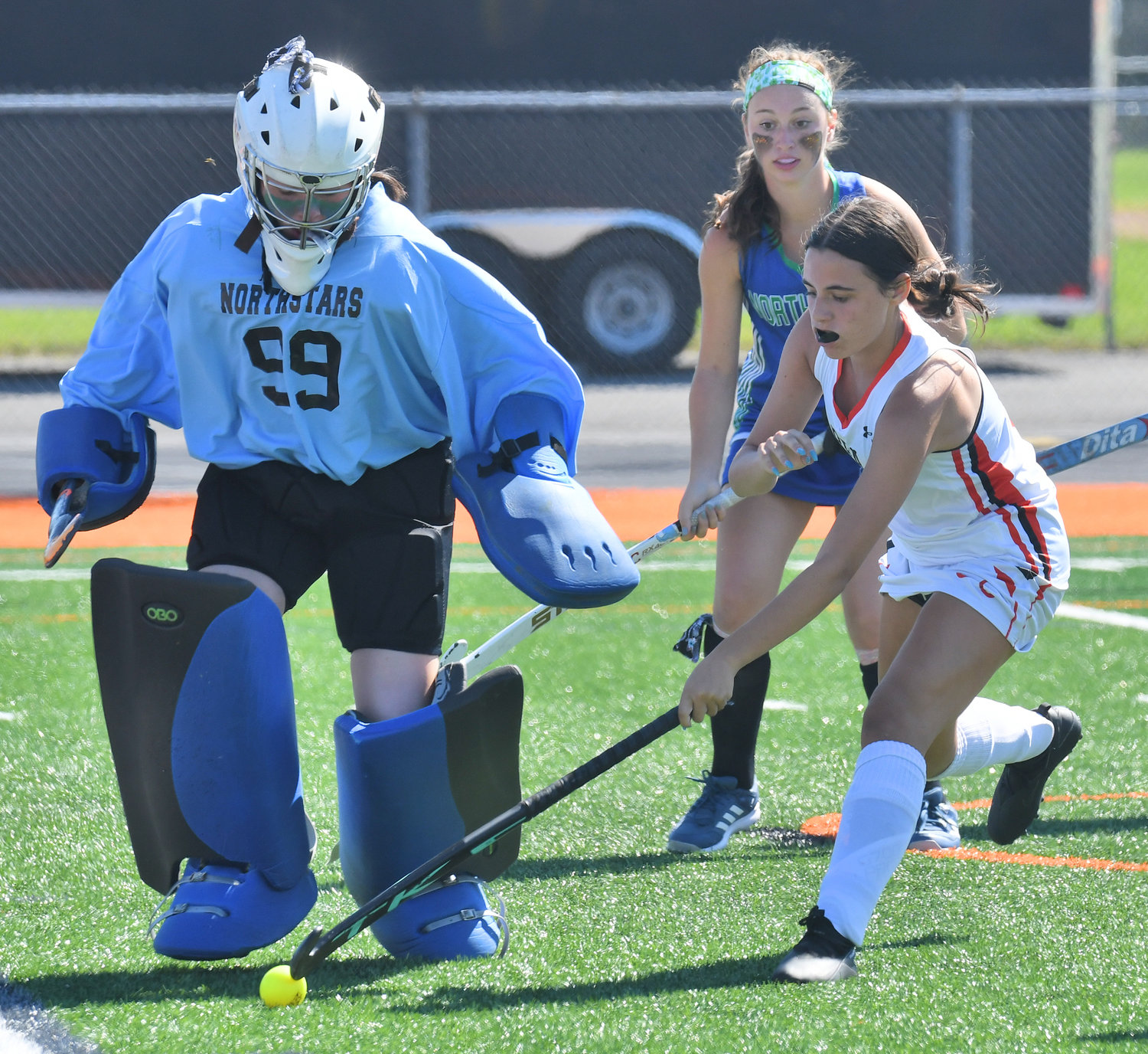 Cicero-North Syracuse goalie Avery Richardson tries to kick the ball away from Rome Free Academy sophomore Dani Kopek during the first half of the field hockey opener Friday at RFA Stadium. The Black Knights lost 5-0.
