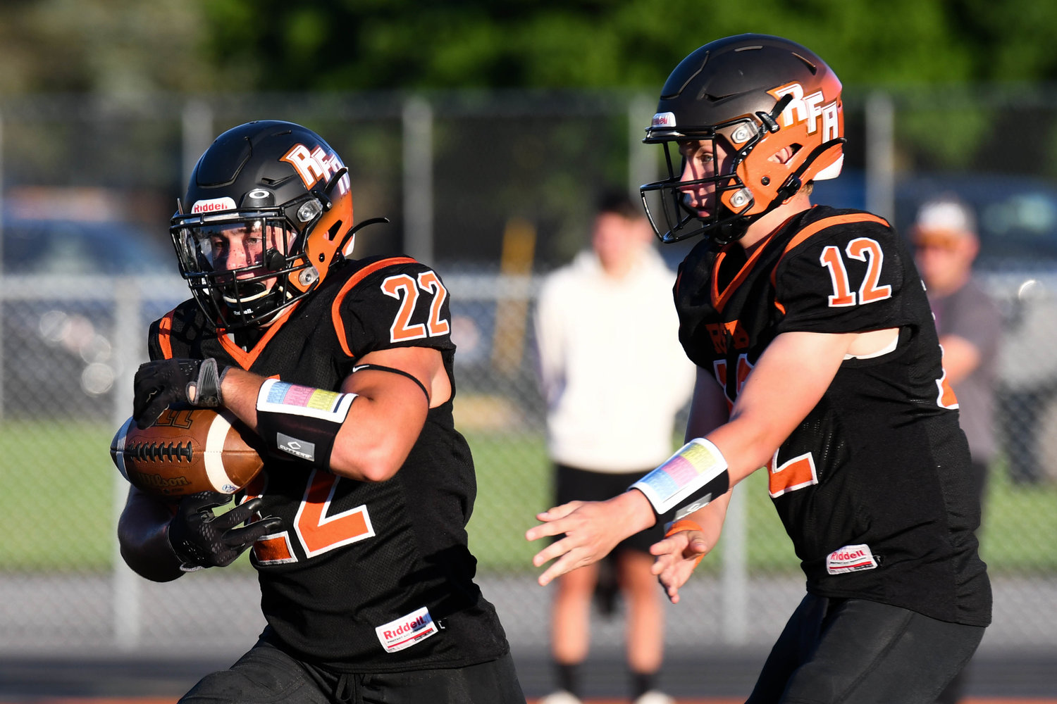 Rome Free Academy running back Salvatore Martelli takes a handoff from quarterback Evan Carlson-Stephenson during Friday's season-opening 52-26 loss to New Hartford at RFA Stadium. Martelli had 77 total yards of offense. Carlson-Stephenson was 20-for-34 passing for 219 yards and three scores.