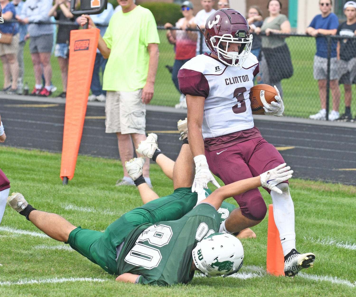 Clinton senior Cameron Maline crosses the goal line to score a touchdown on a 58-yard punt return in the second quarter during Saturday afternoon’s non-league game against host Westmoreland/Oriskany. Westmoreland’s Gino Marangi tries to make a play at the goal line. The Warriors won 28-6.