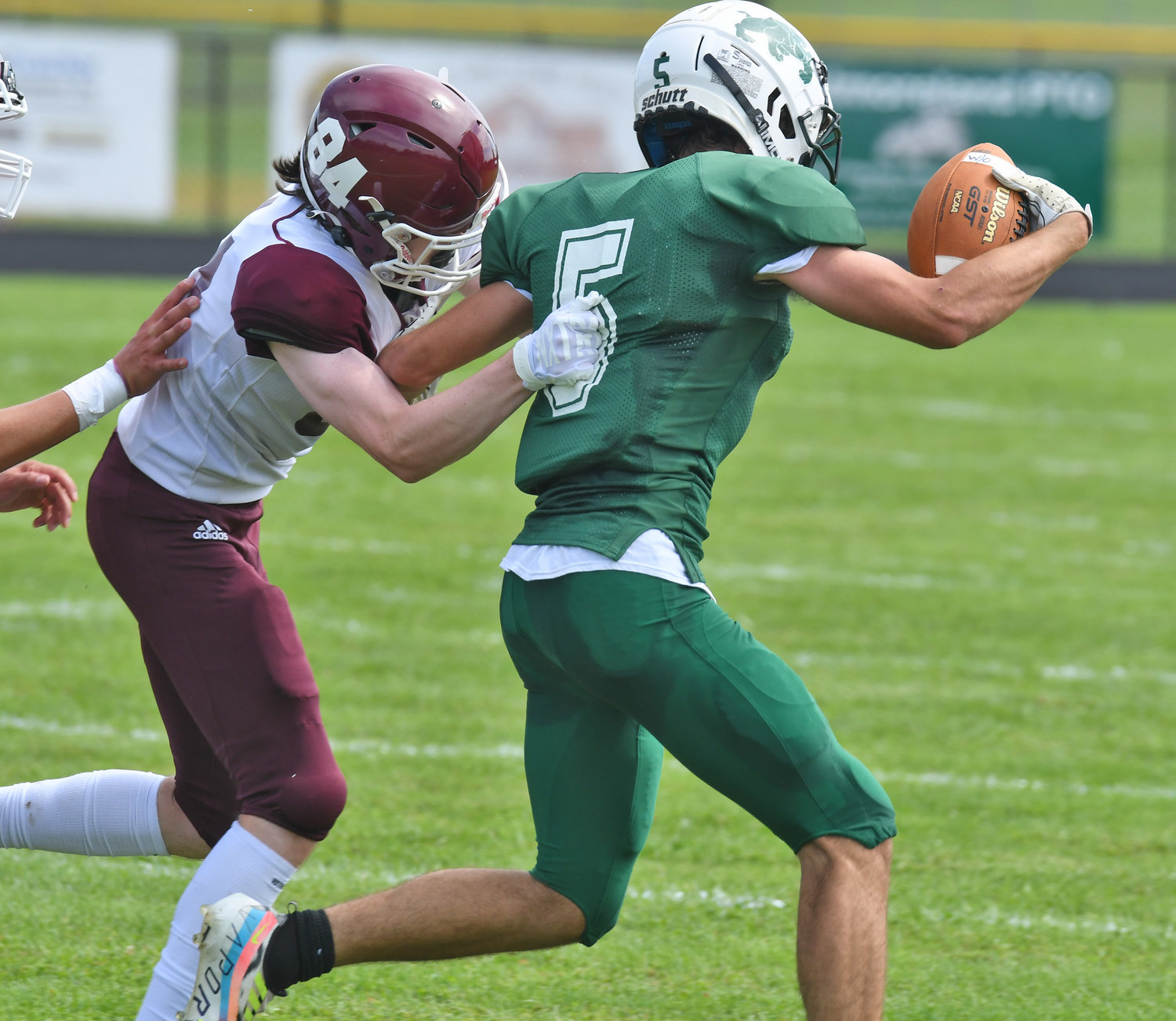 Westmoreland/Oriskany's  Cameron Rautenstrauch zips around end for a gain before being tackled by Clinton's Ronan Milne during Saturday afternoon's non-league game in Westmoreland. The Warriors won 28-6.