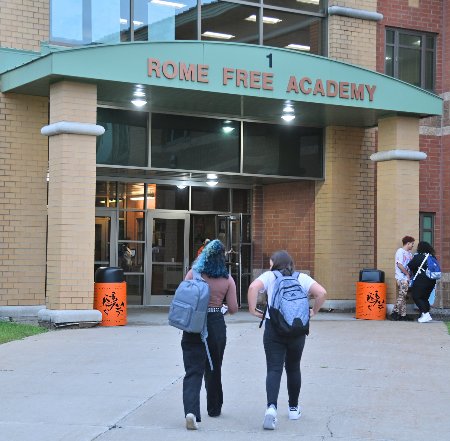 A pair of ninth-graders head toward the main entry into Rome Free Academy on Wednesday, Sept. 7, on their first day of classes for freshmen.
