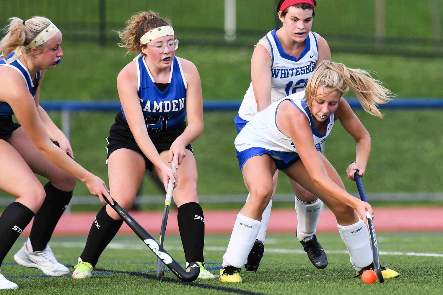 Whitesboro player Brianna DeHimer, right, moves the ball against Camden players Emily Bird, left, and Lillie Howe during the field hockey game on Wednesday. DeHimer scored in the game, but Camden won 2-1.