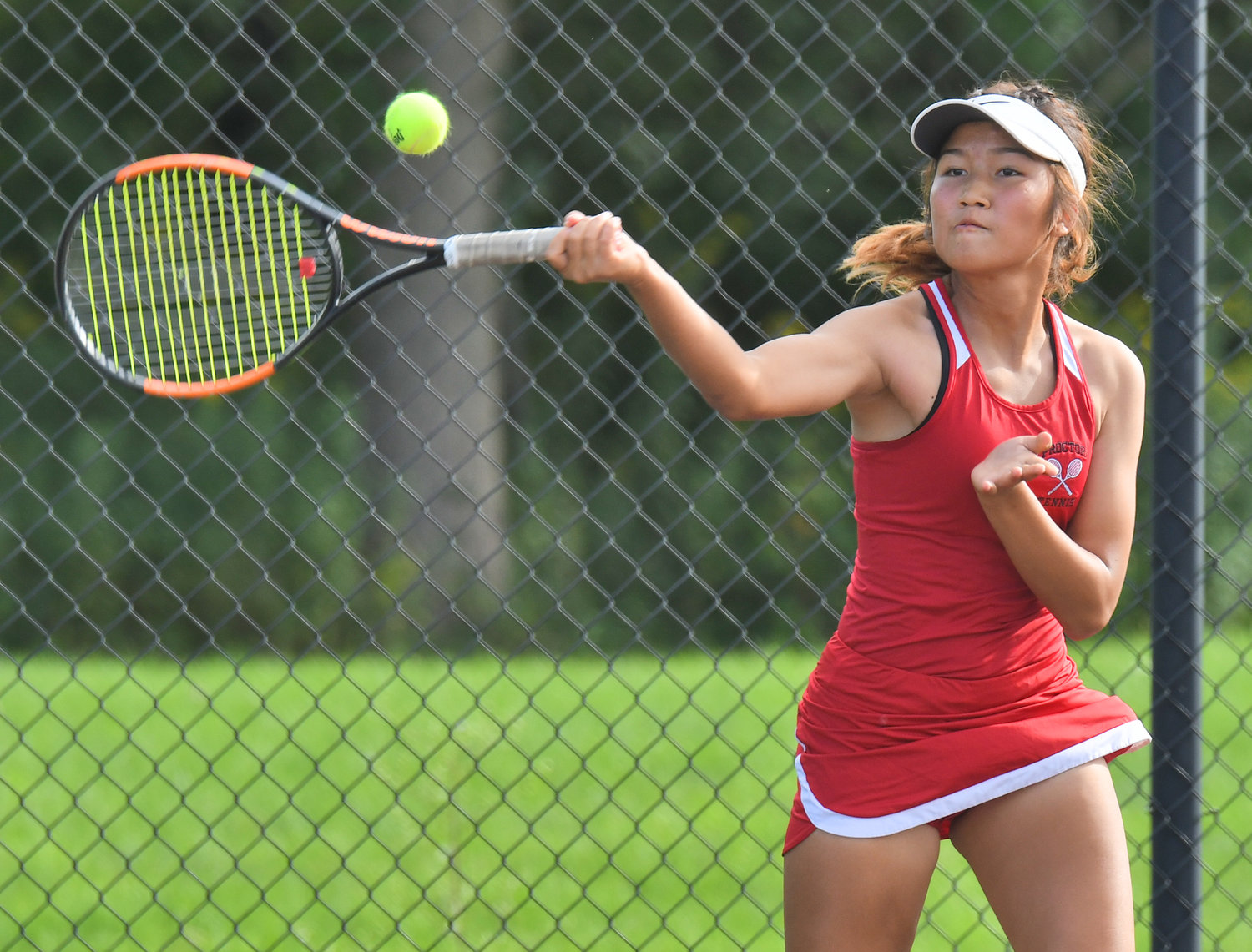 Utica-Proctor’s Tha Kyet returns shot in her first singles match against Rome Free Academy’s Jenna Cianfrocco at the RFA tennis courts Wednesday afternoon. Kyet won 6-1, 6-3 and the Raiders won the match 4-3.