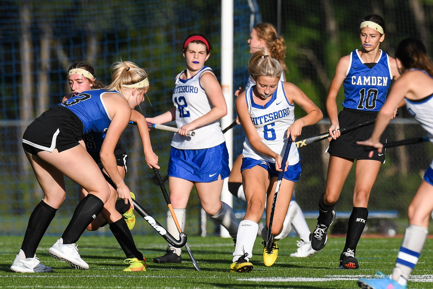 Whitesboro player Brianna DeHimer (6) moves the ball against Camden players Emily Bird (3) and Avery Prievo (10) during the field hockey game on Wednesday.