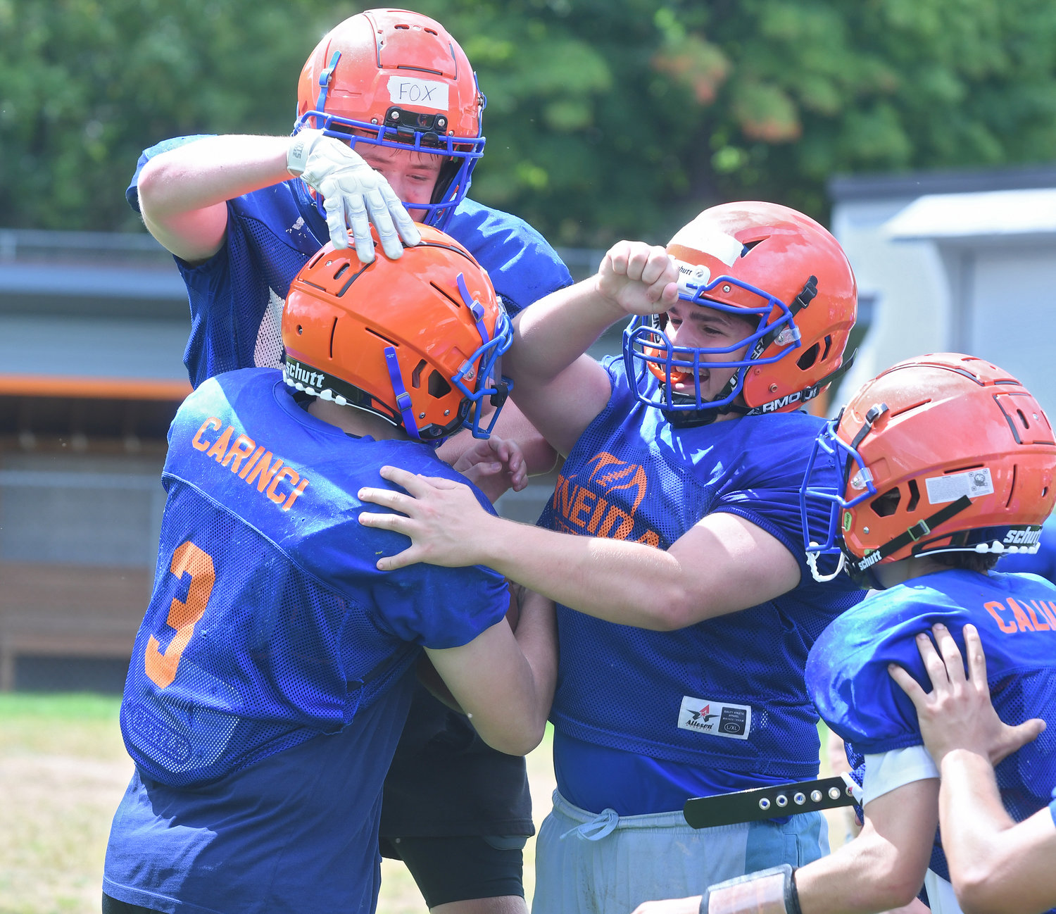 The Oneida football team celebrates a touchdown during practice. Players mob junior quarterback Bryson Carinci, left. Carinci returns after starting last season as a sophomore.