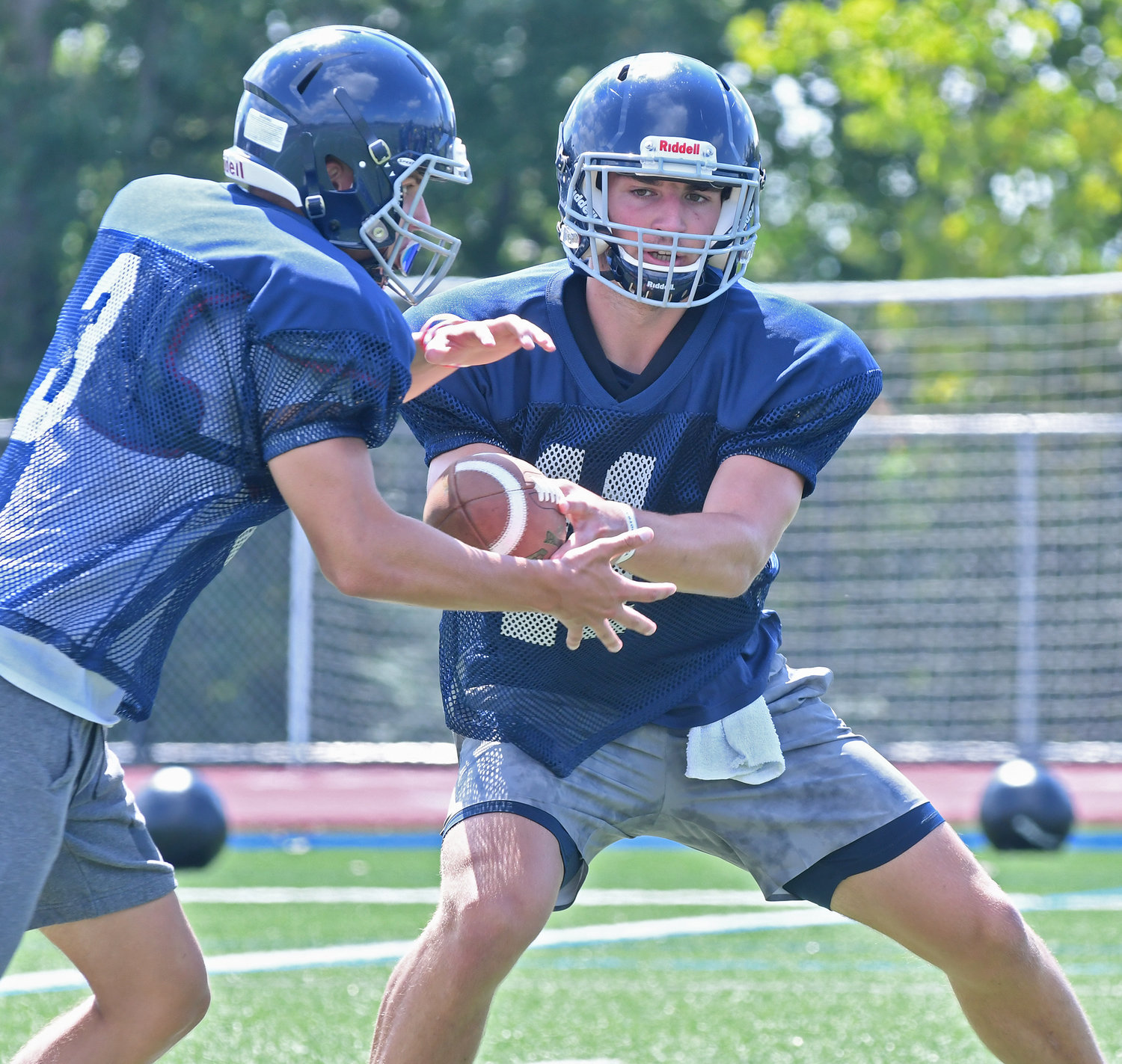 Whitesboro quarterback Kyle Meier hands the ball off to running back Nicholas Polnak during practice at Edwin Wadas Athletic Complex.