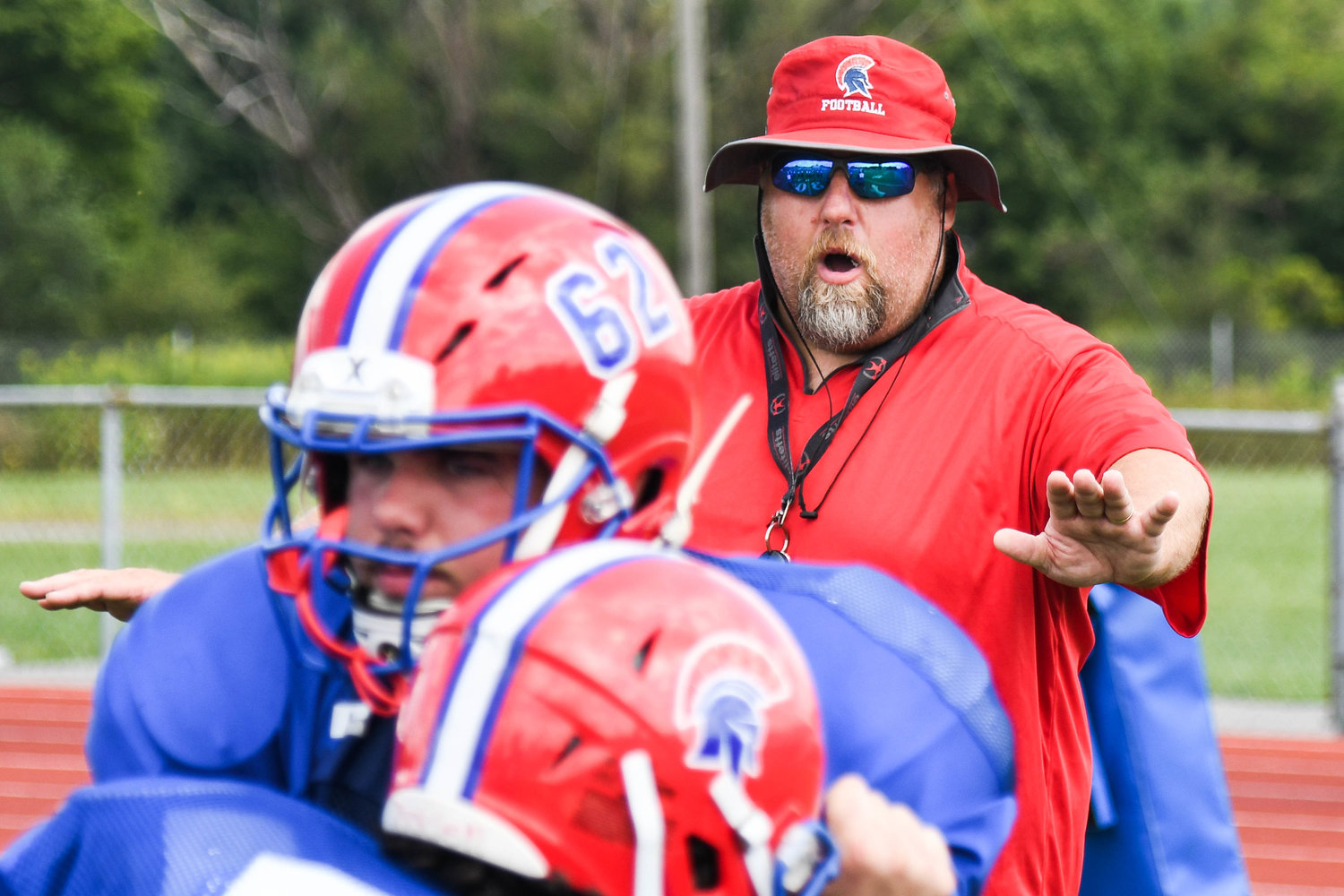 New Hartford coach Ted Swavely works with linemen during a recent practice.
