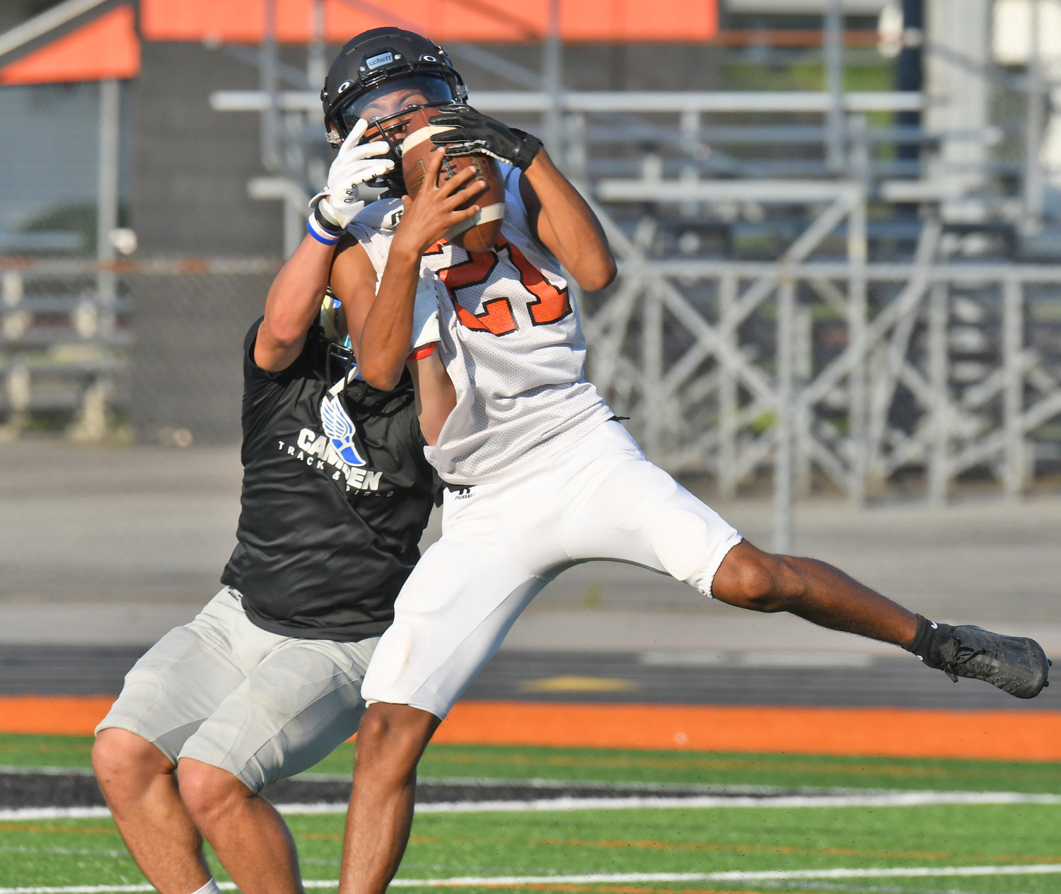 Matthew Lambert of Rome Free Academy makes a catch in front of Camden defender Robby Jackson during a seven-on-seven scrimmage on Aug. 29 at RFA Stadium.
