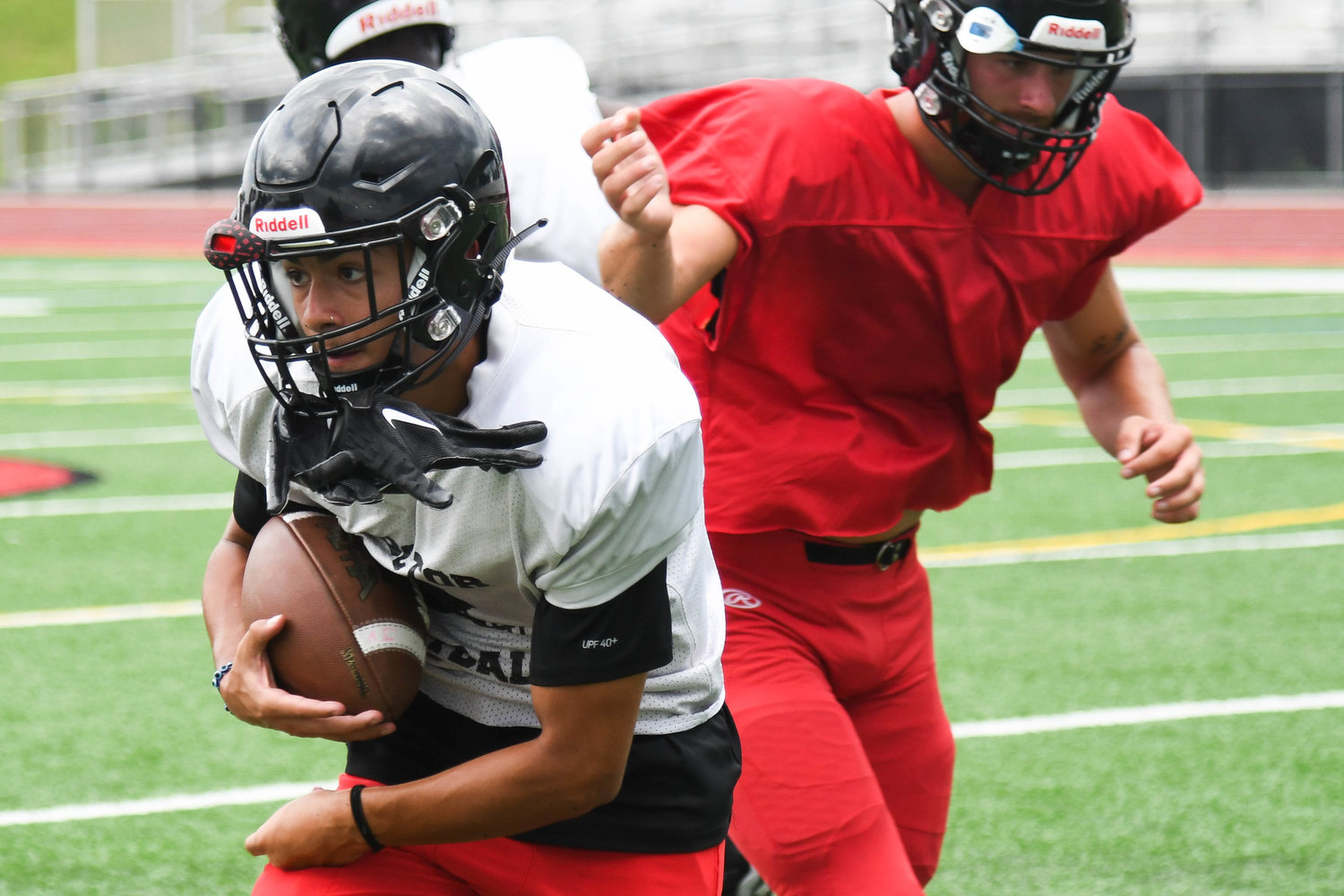 Proctor’s Israel Matos takes a handoff on a jet sweep during practice on Aug. 30. The Raiders return a mix of experience for the fall season.