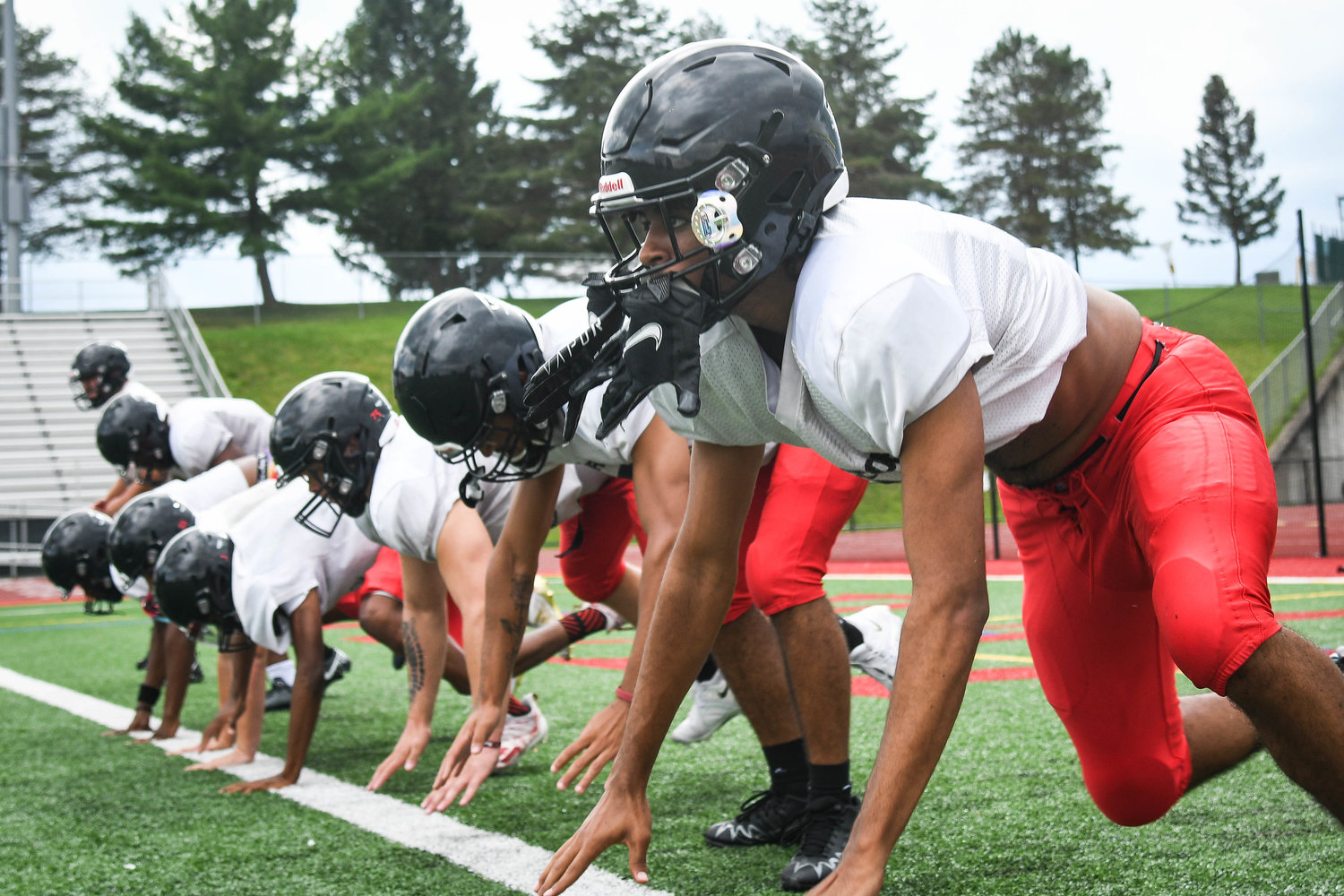 Proctor players grind through up down drills during practice on Tuesday, August 30.